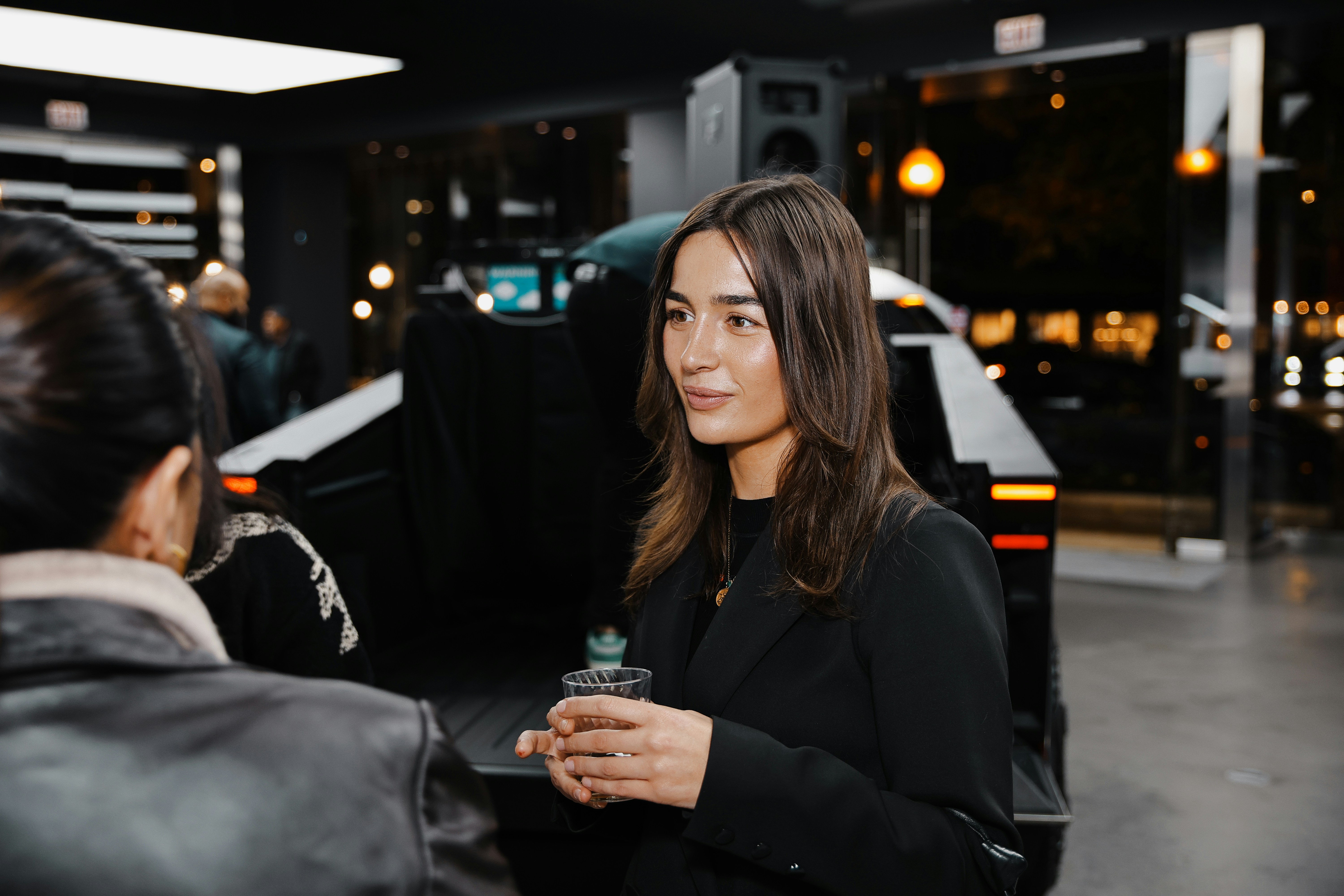 A woman standing next to a woman in a black jacket