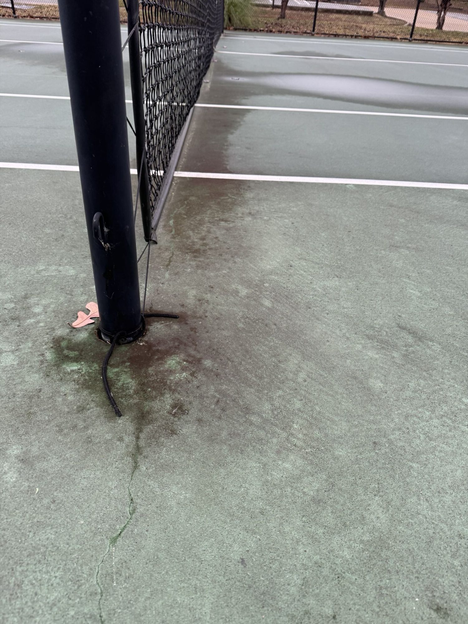 Hairline crack running from the net post before resurfacing in Maumelle, AR