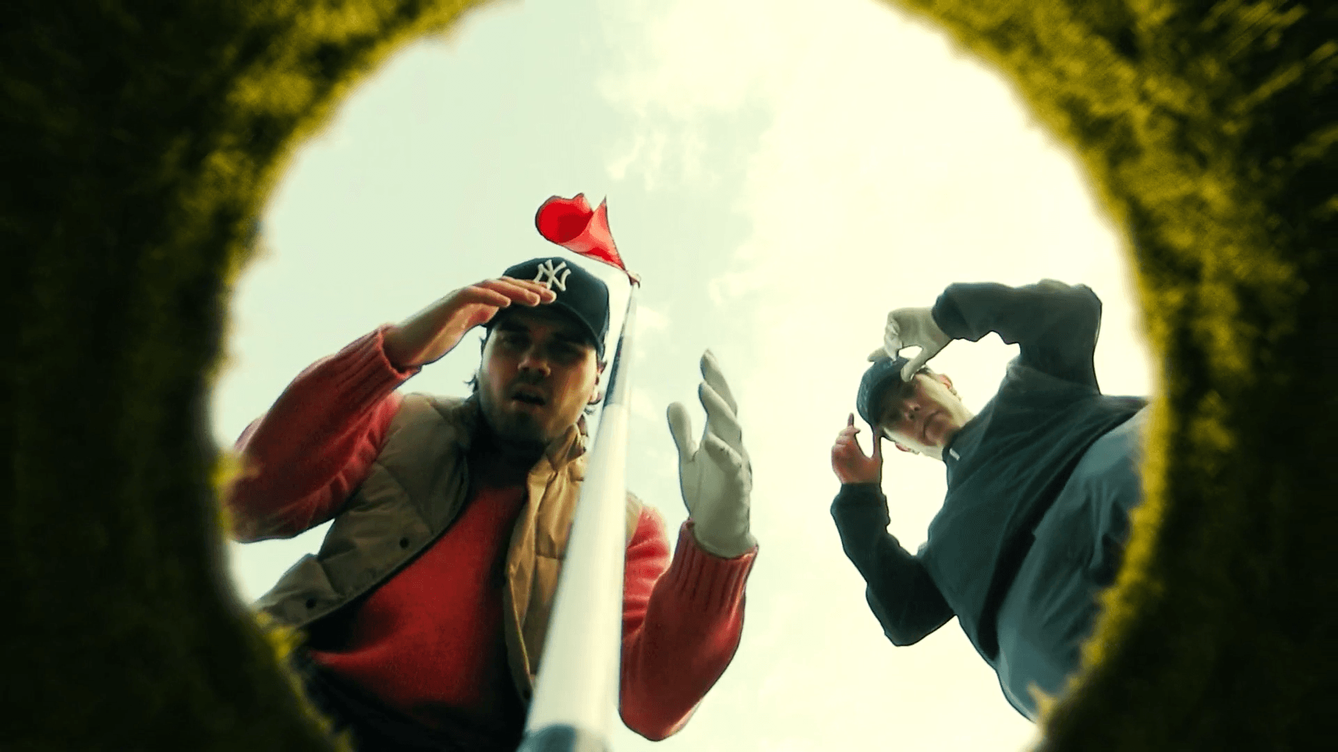 Looking through tennis hole flag two men playing tennis looking through goal