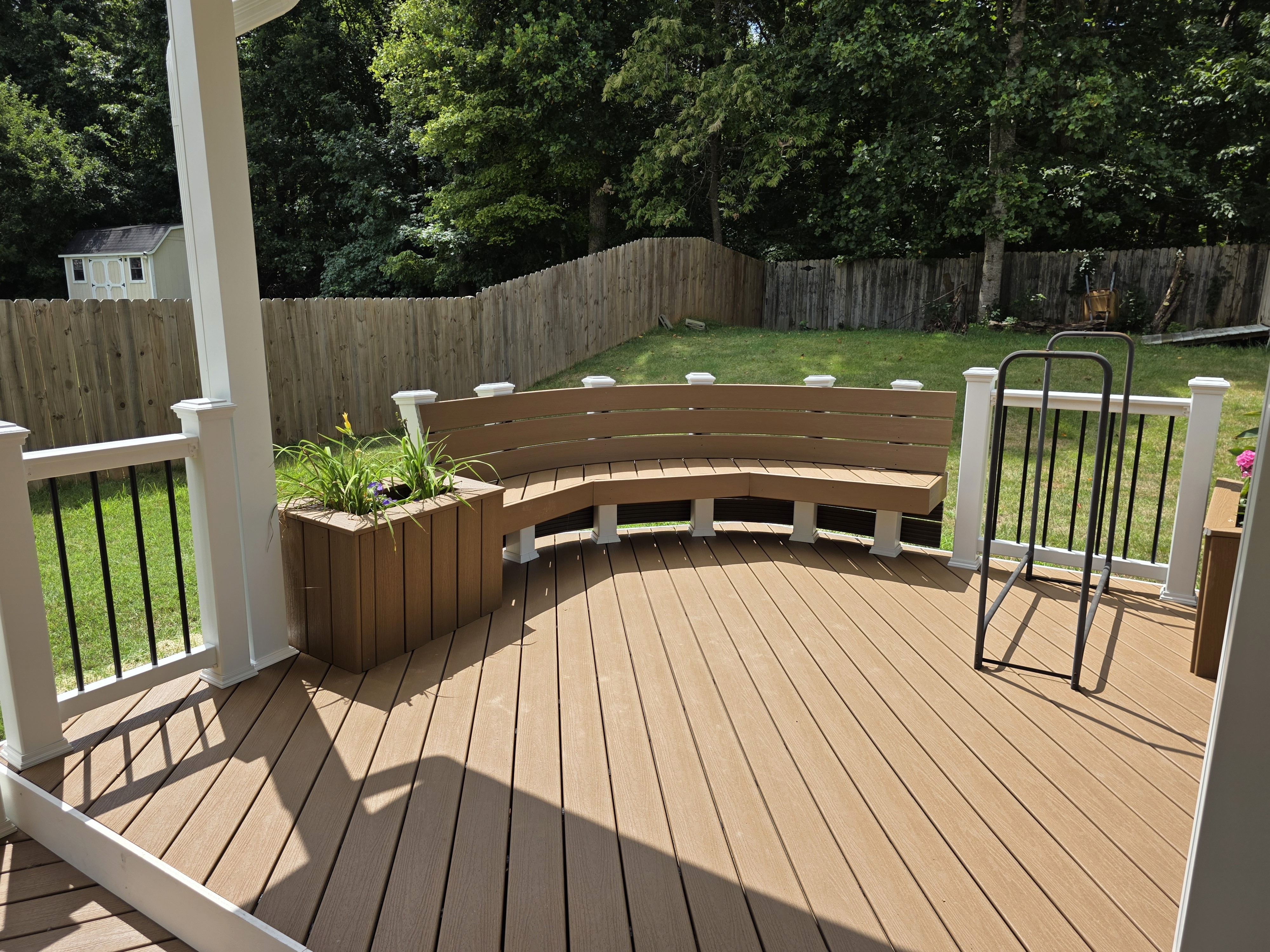 Trex composite deck with white vinyl railings and black balusters in Jamestown NC.