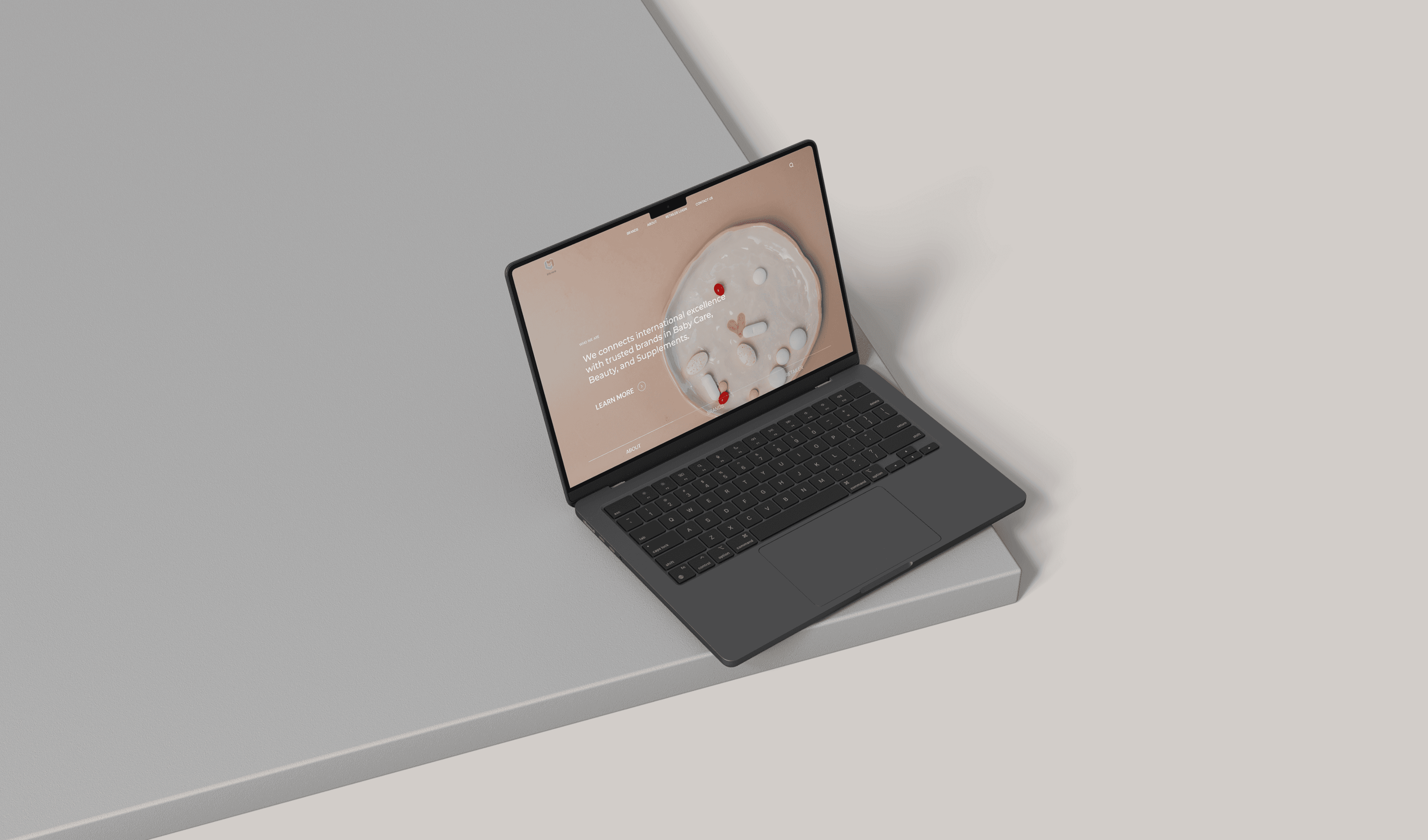 "Mockup of a sleek black laptop displaying a modern website for a baby care, beauty, and supplements brand, showcasing international excellence and trusted products."