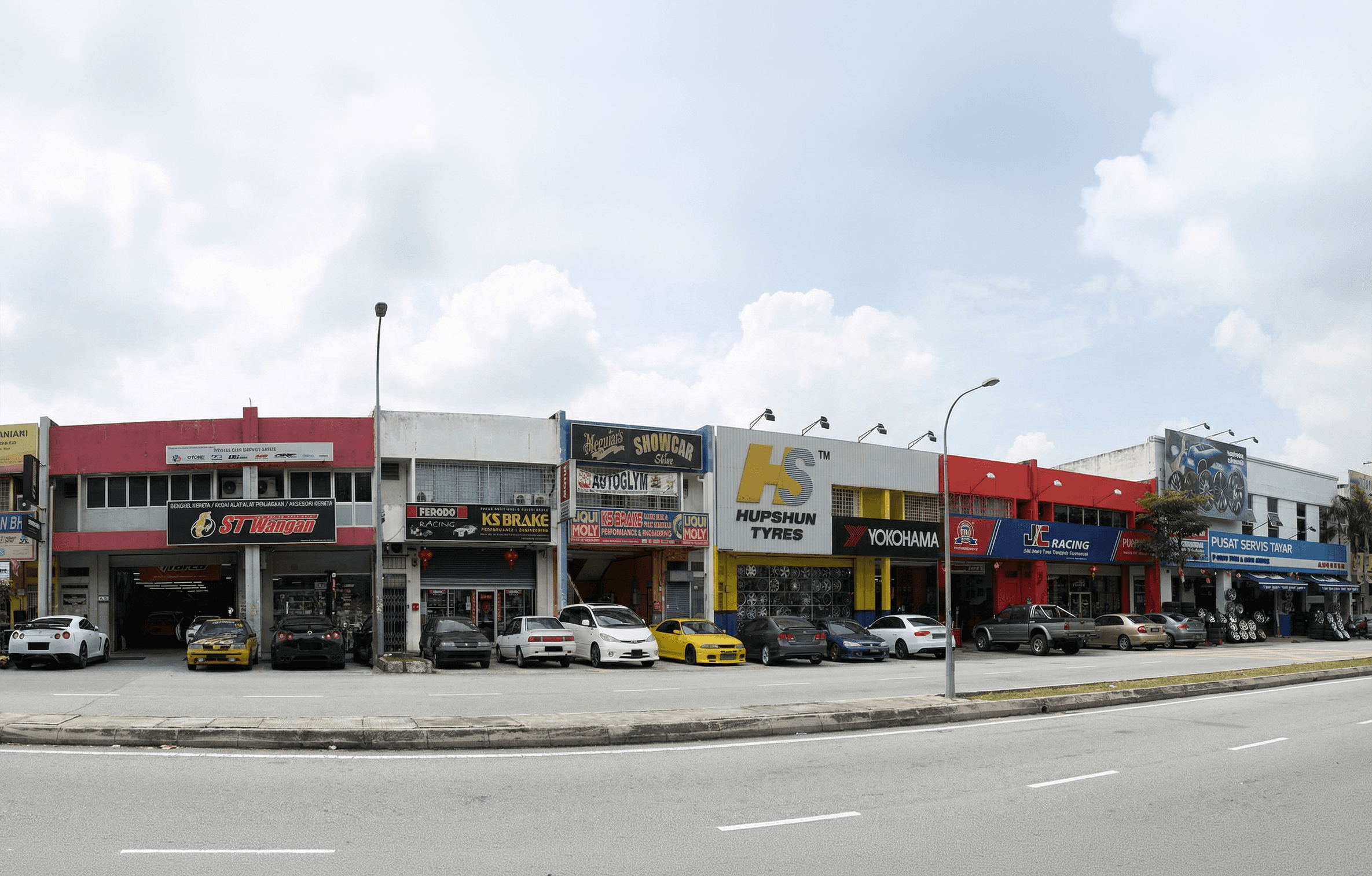 grey vehicle parked near white concrete building
