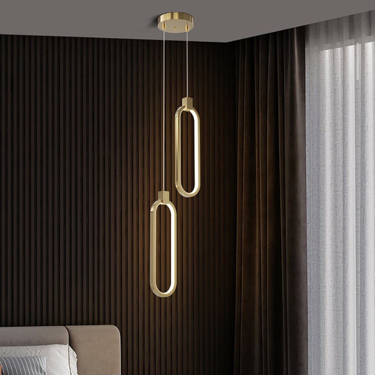 Gold eometrical chandelier light hanging from the ceiling in a bedroom.