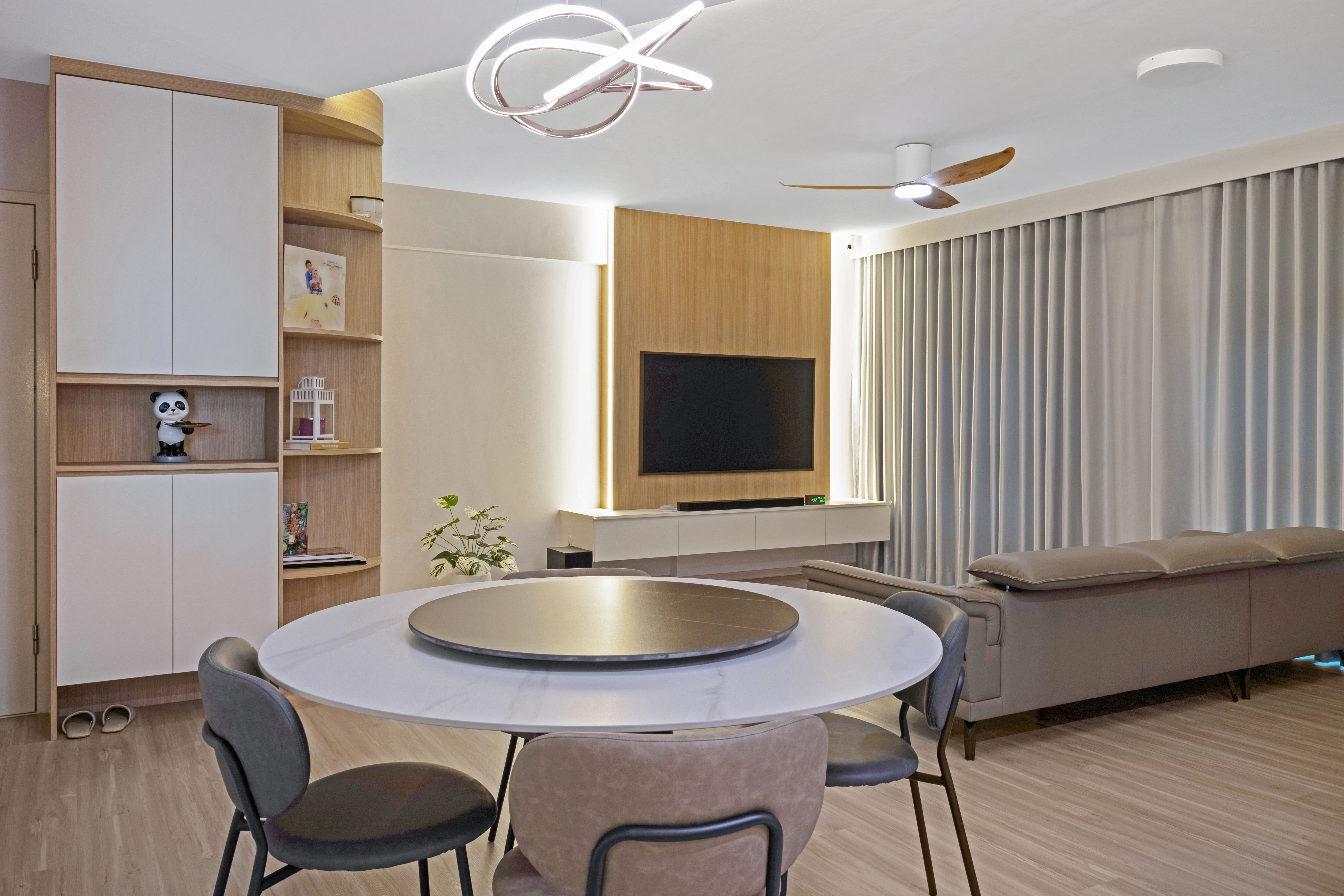 Dining nook with a round marble-top table, complemented by modern pendant lighting and a window to the kitchen for seamless connection.