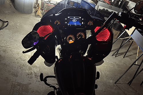 A person stands in a sandstone cave.