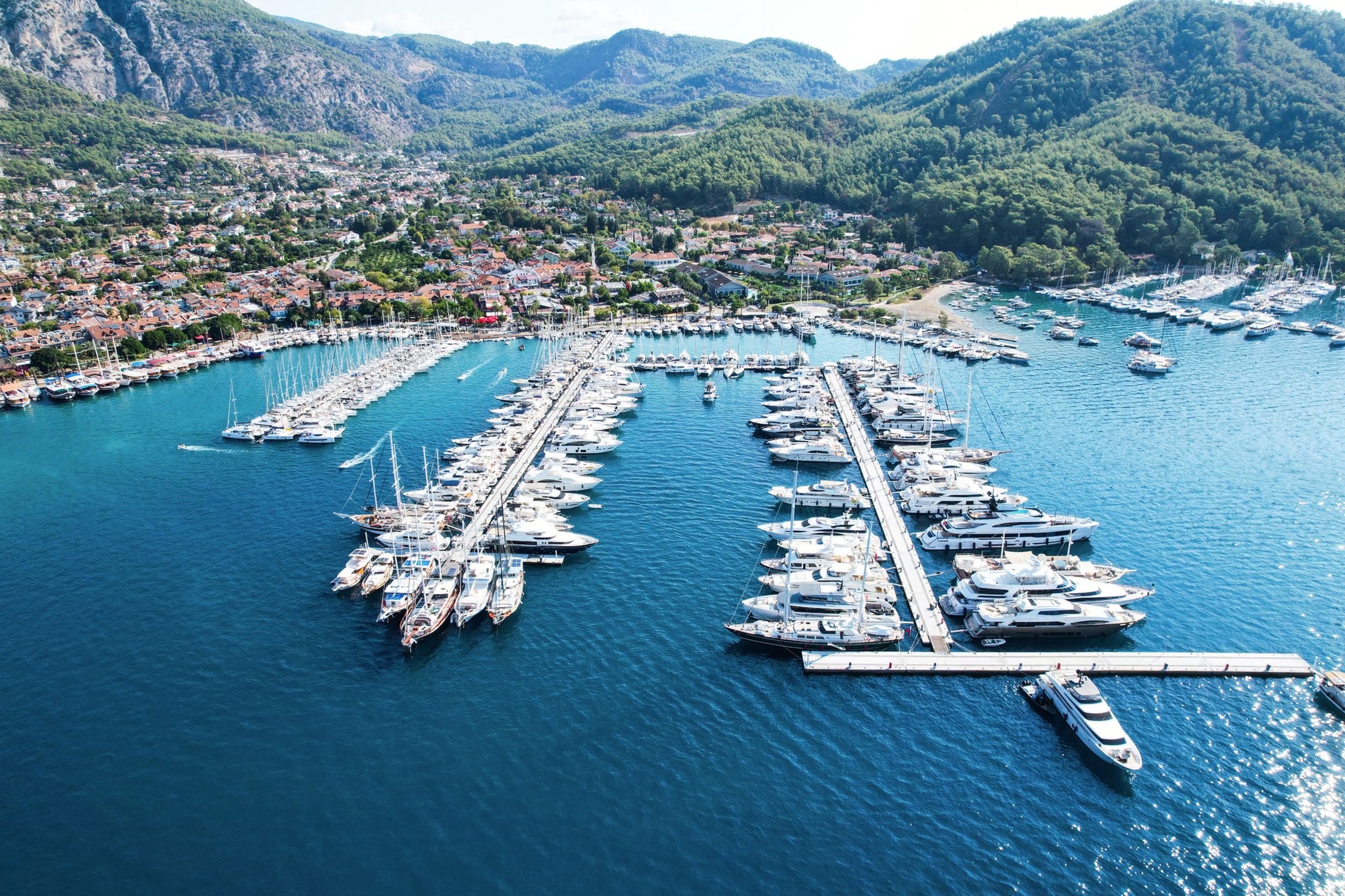 Aerial view of Göcek Marina in the Turkish Mediterranean, showing yacht berths and port facilities.