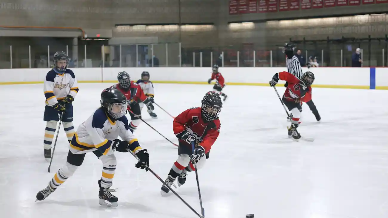 Young ice hockey players competing during a youth tournament, representing family-friendly sports sponsorship, responsible brand activations and safe sponsor engagement at youth sporting events.