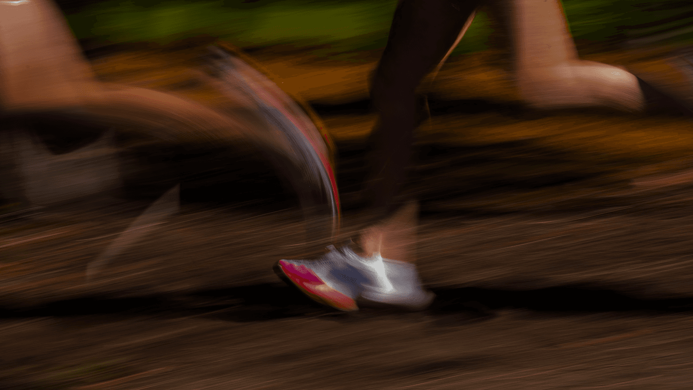 Running shoes in motion, close-up shot with motion blur on outdoor path