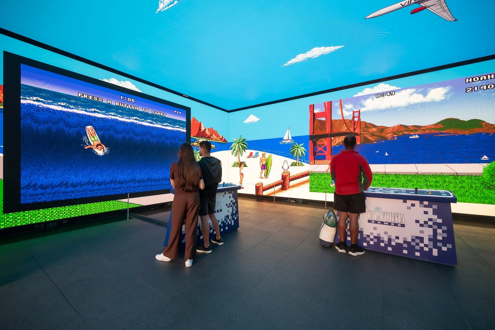 Visit California interactive games area at Outernet London, featuring large-scale digital screens, California-themed arcade content and guests playing branded experiences.