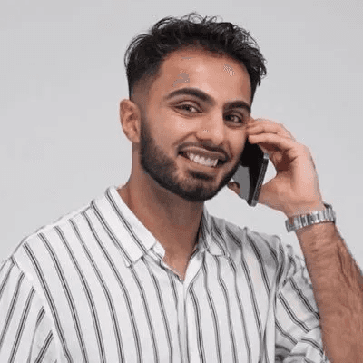 A man works on a laptop in an office.