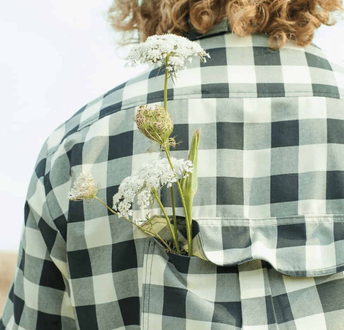 Flowers tucked in a checkered shirt pocket.