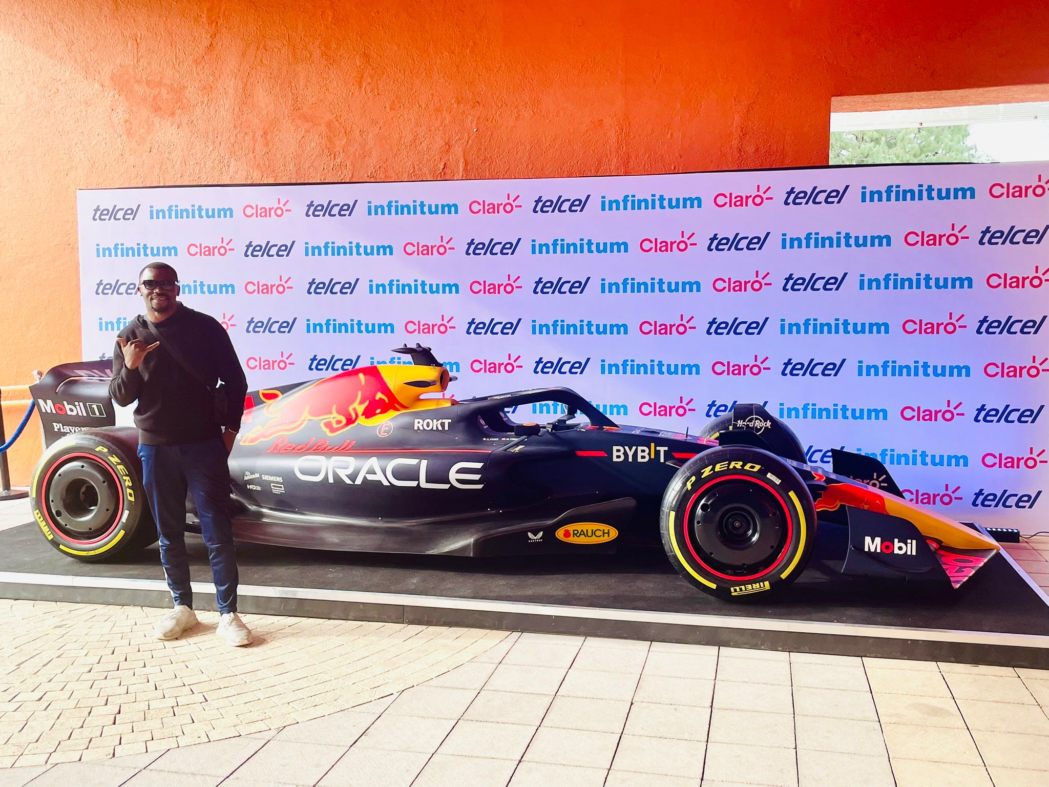 man standing in front of a formula 1 car