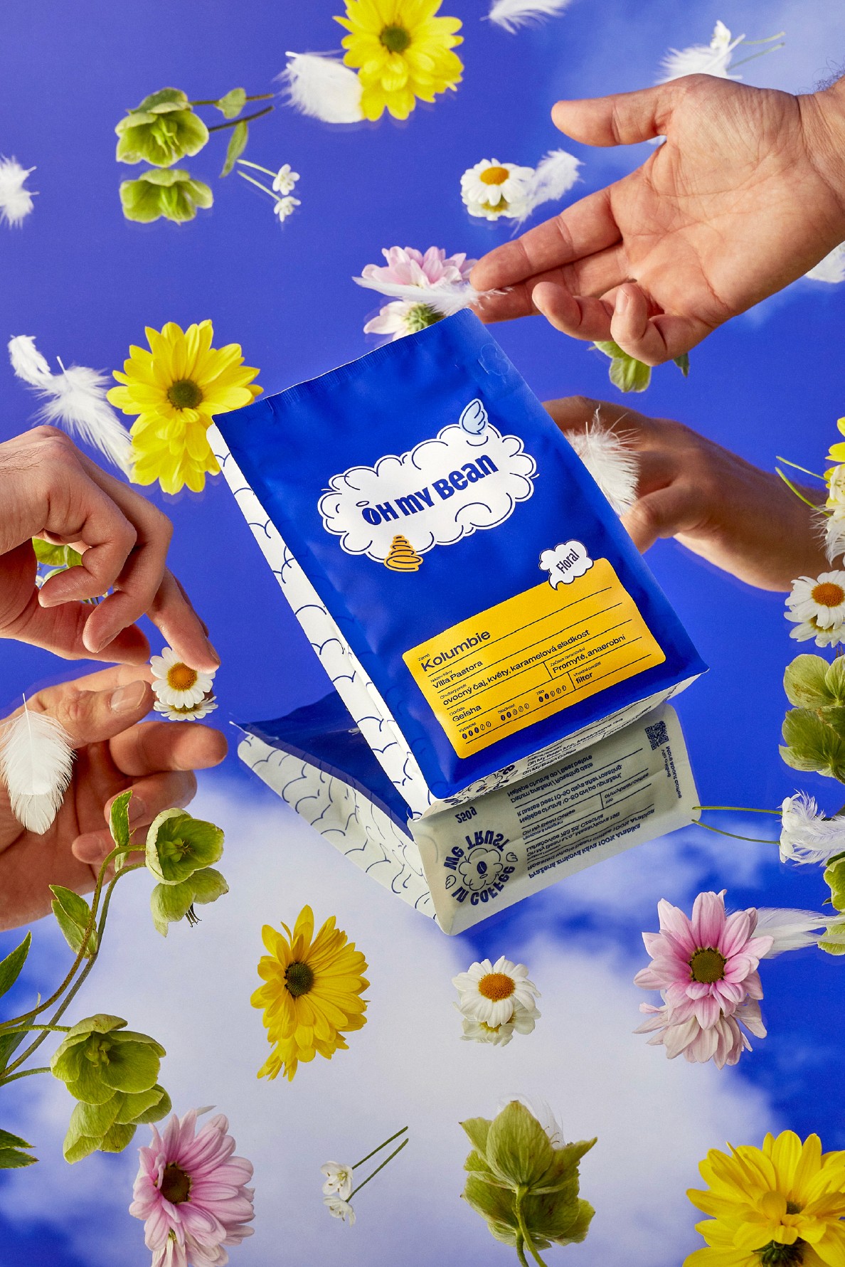 Oh My Bean Colombia Geisha coffee held in hands, surrounded by flowers