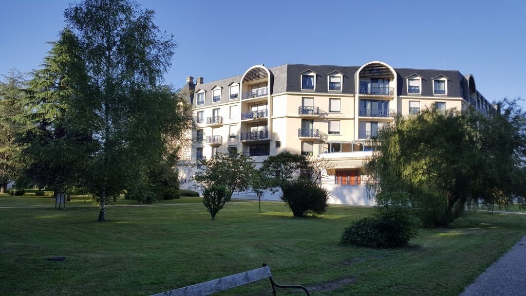 Main entrance of residence with modern facade	accessible entry	and surrounding greenery