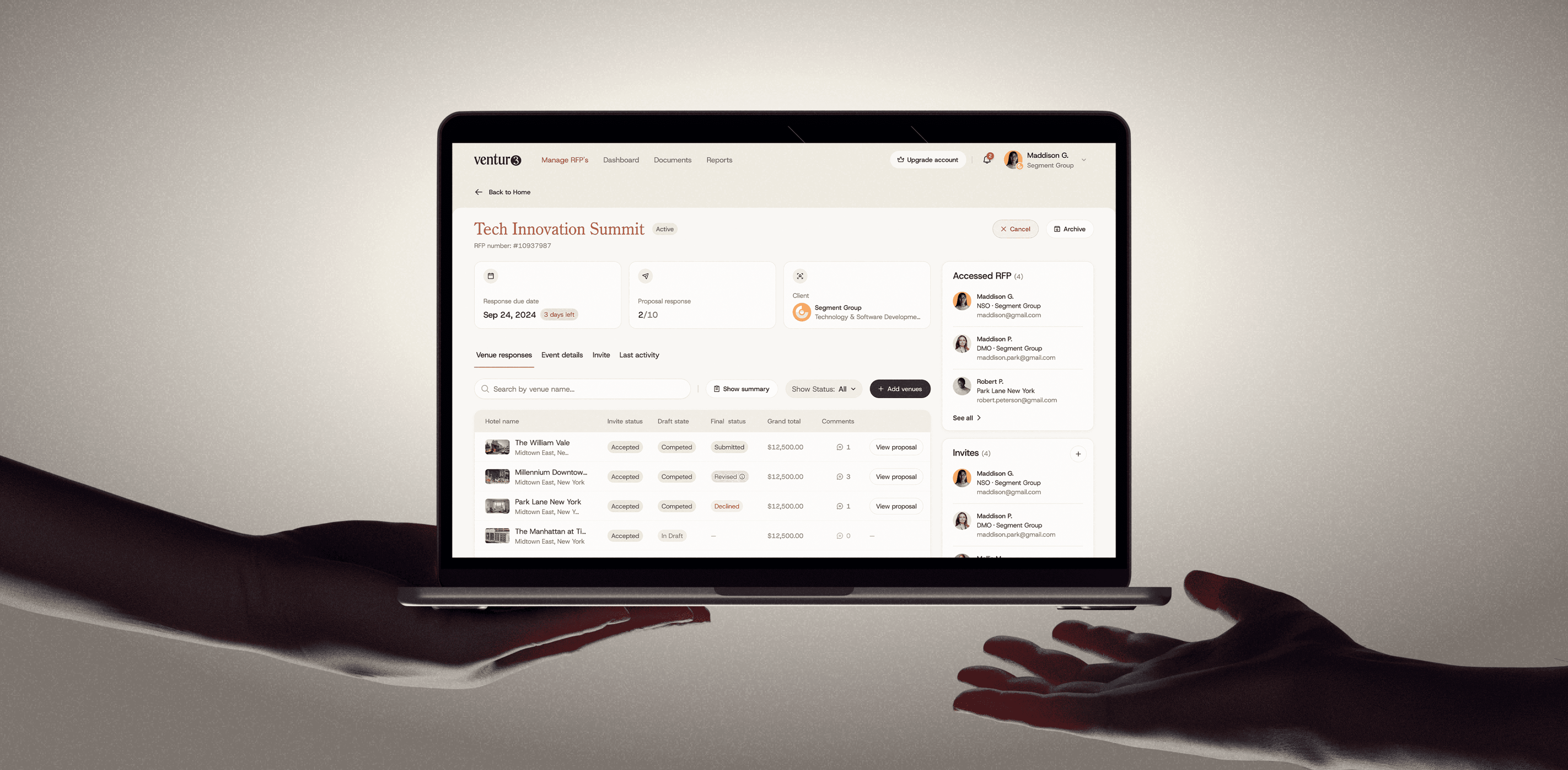 Two hands reaching out to hold a tablet displaying data charts and graphs against a plain background.