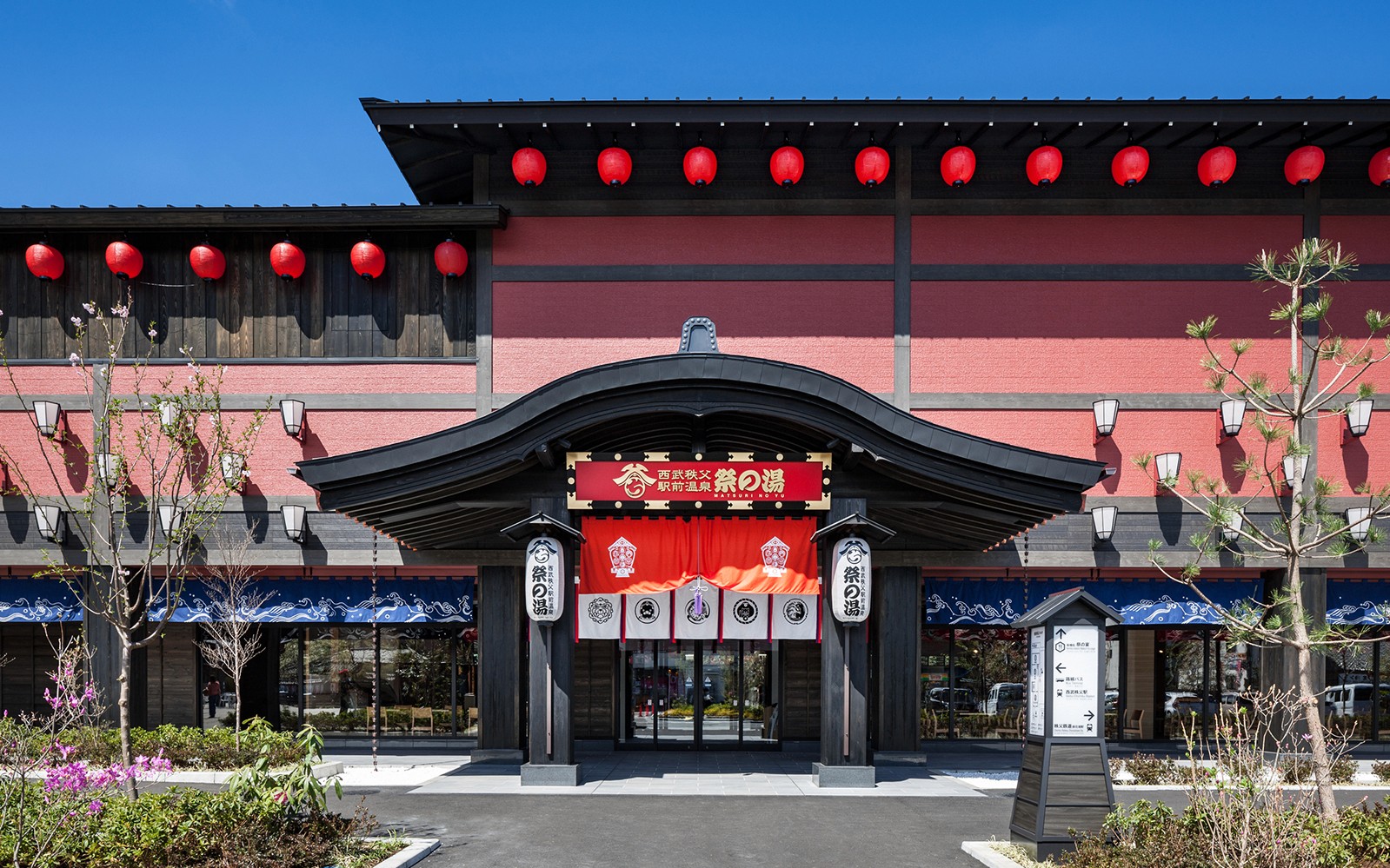 Traditional Japanese building with red lanterns, part of Seibu Pass tour in Japan.