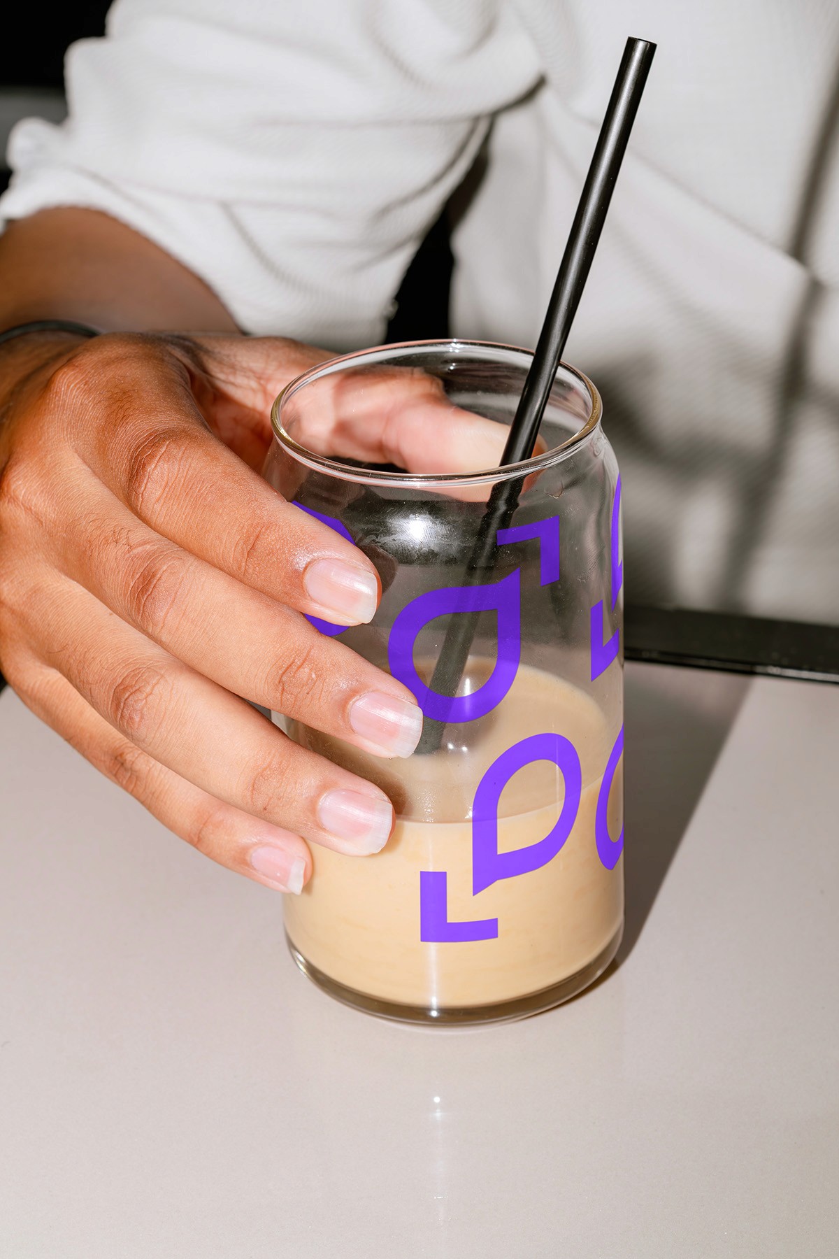 Stacked square glass jars filled with golden serum and bubbles, silver lids—luxury skincare packaging on a light background.