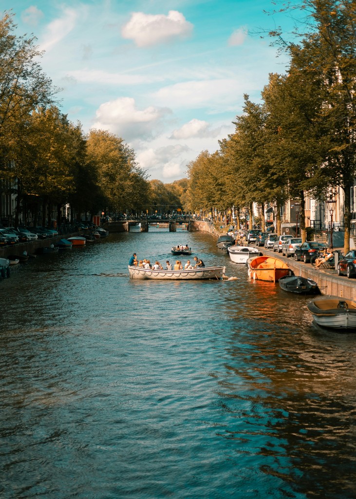 a group of boats are parked on the side of a river