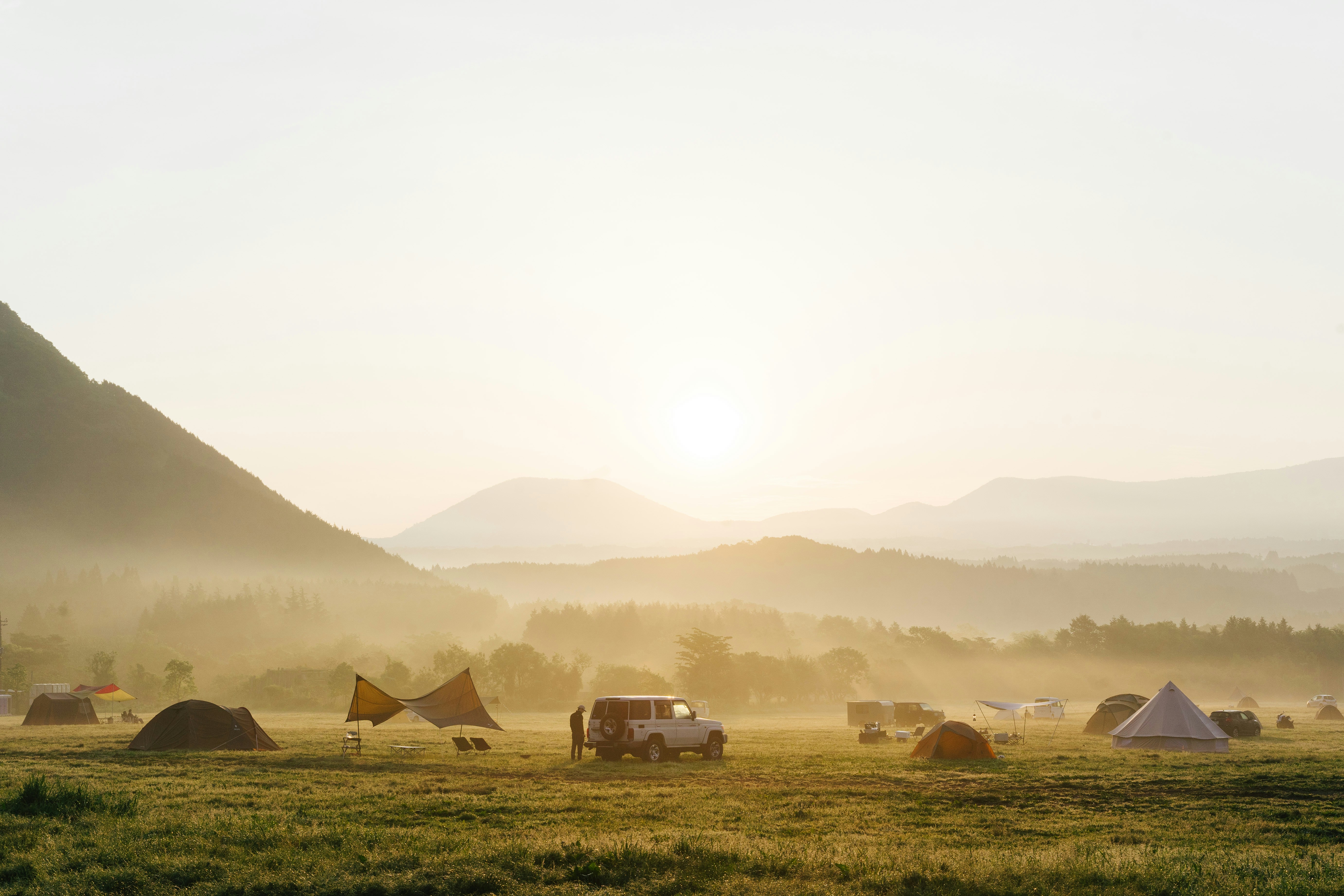 person camping in green fields