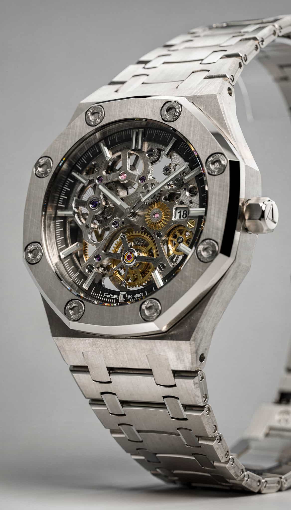 a runner's muddy trail running shoe mid-stride, poised above a rocky mountain terrain