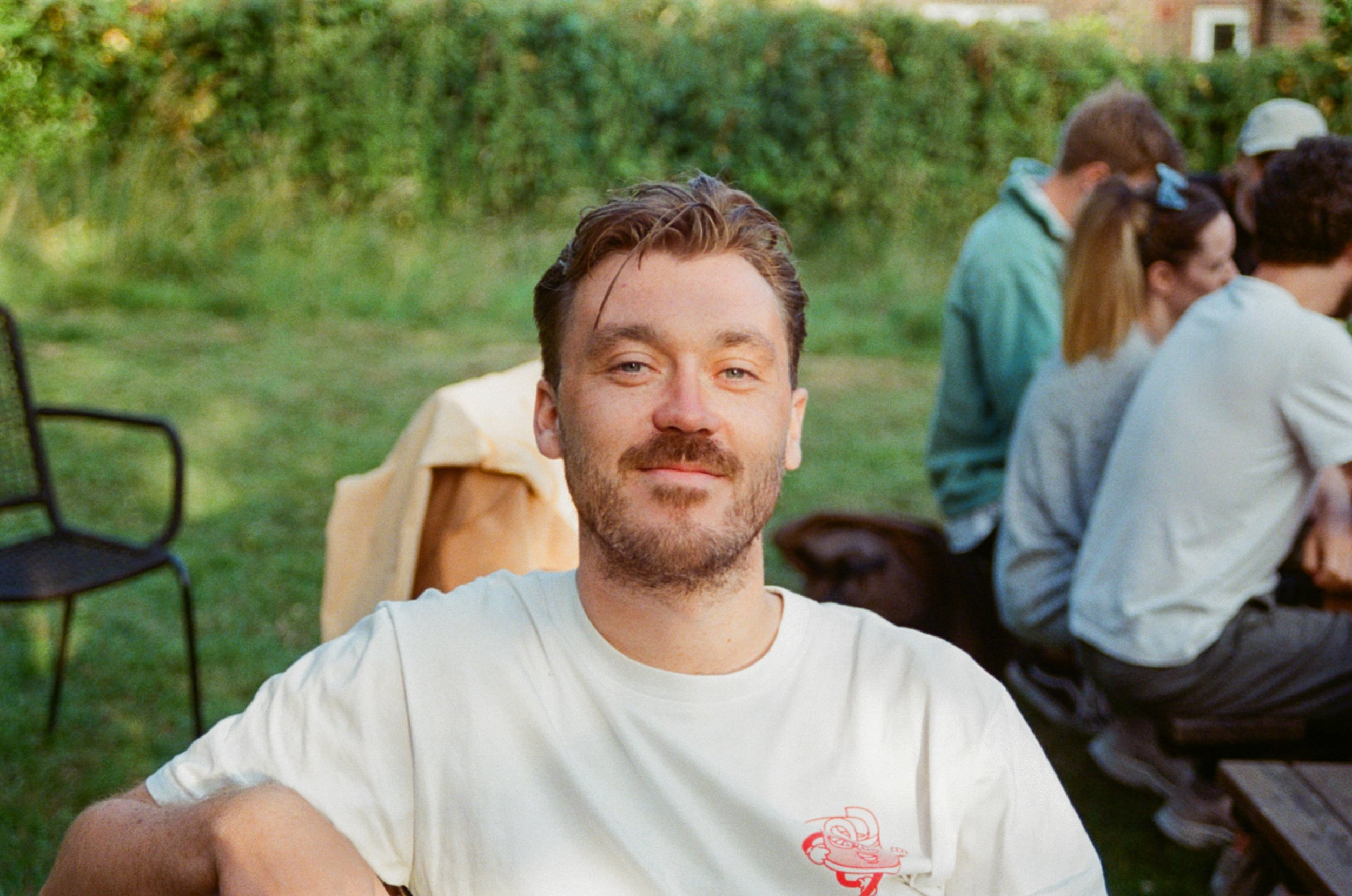 Photographer Joe McCaig posing in a garden setting