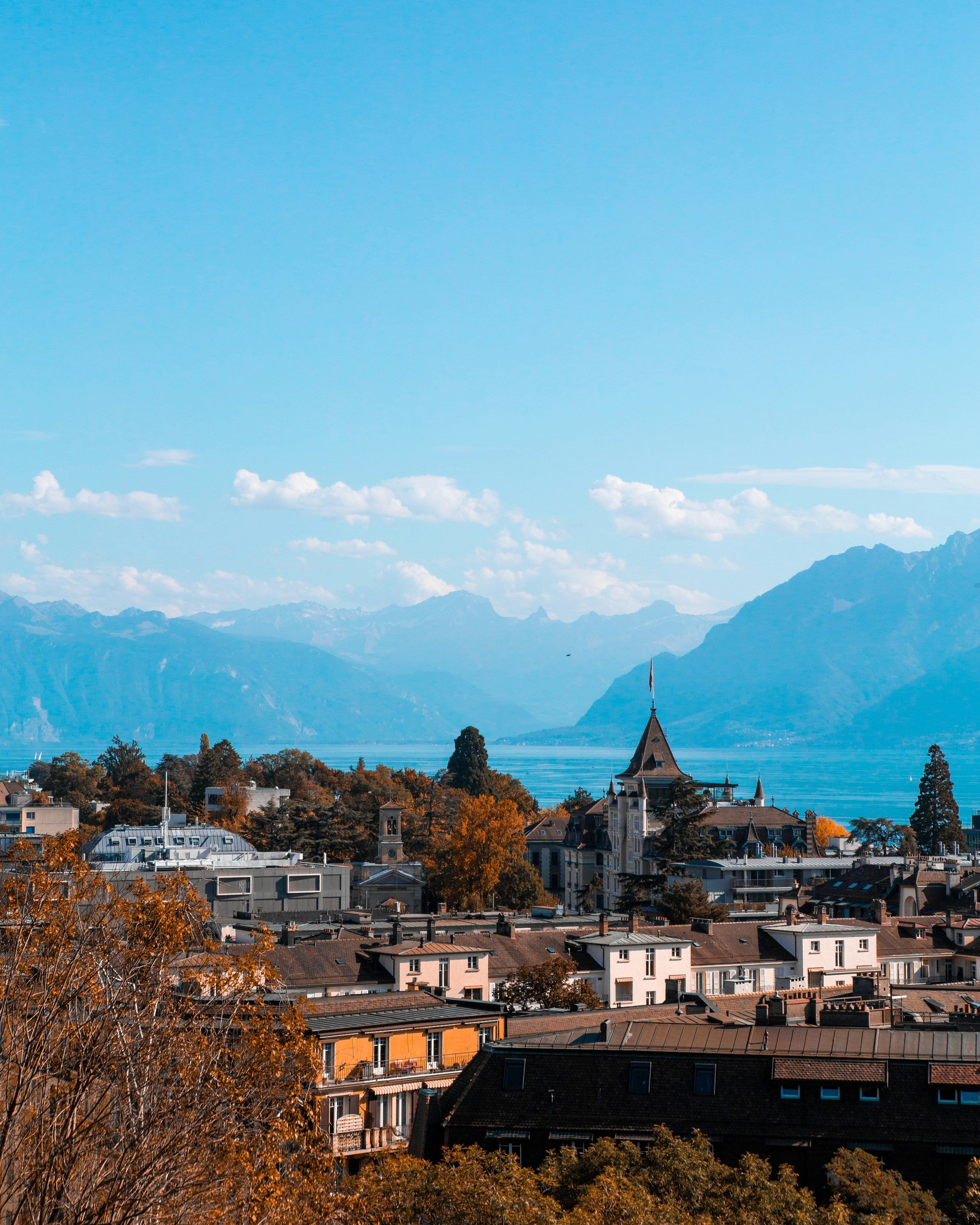 Aerial view of Lausanne, Switzerland with Lake Geneva and the Alps in the background.