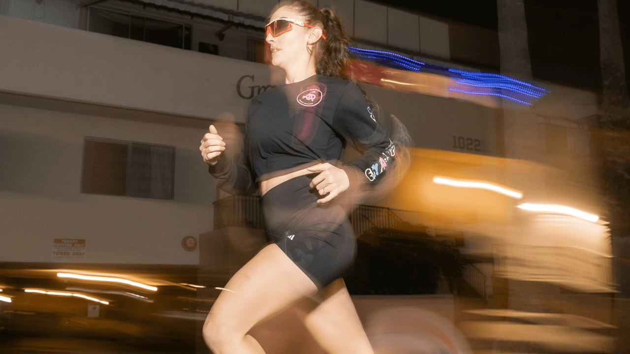 a woman running on a city street at night