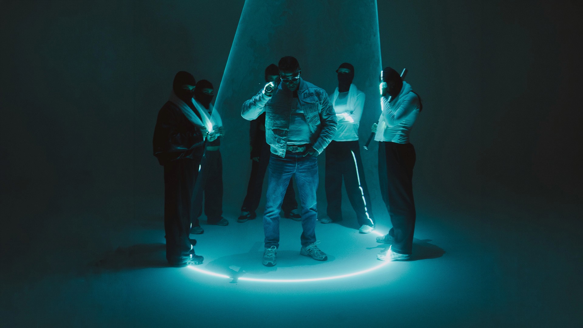 group of people with a laser above in blue beam light