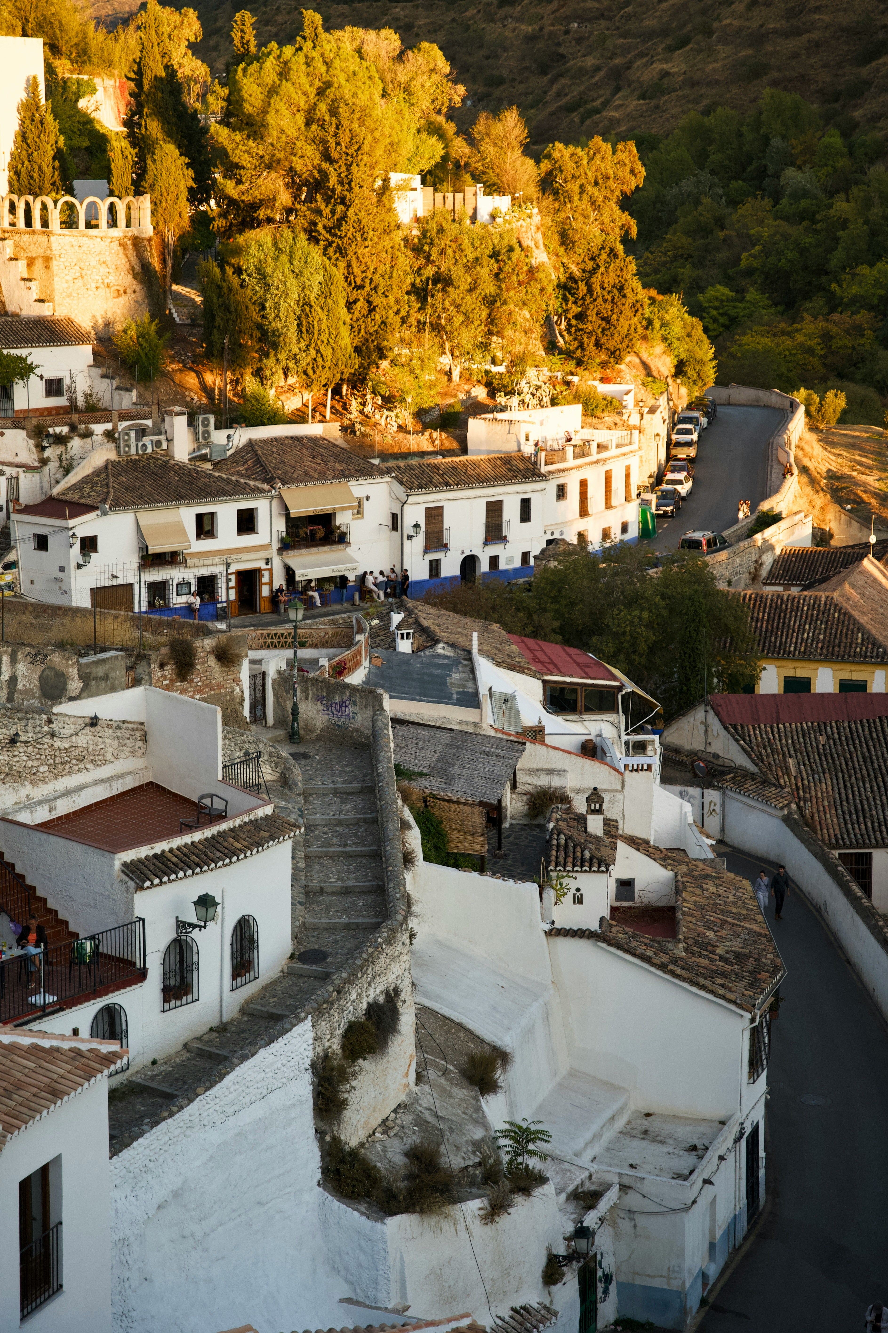 White buildings on a hillside at sunset.