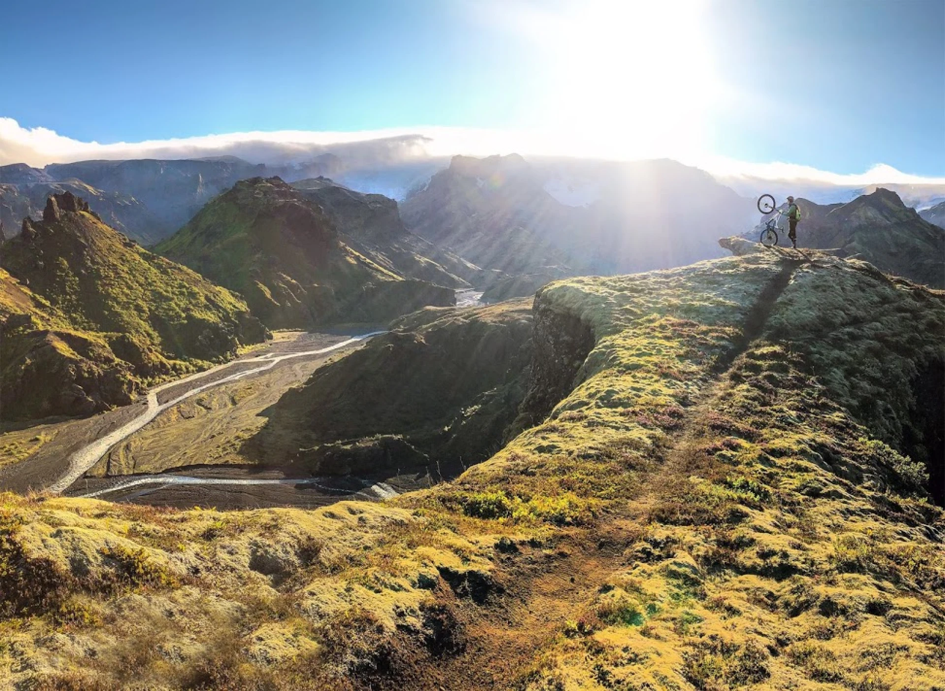 one mountain bike rider in garden of Thor with sun low on horizon