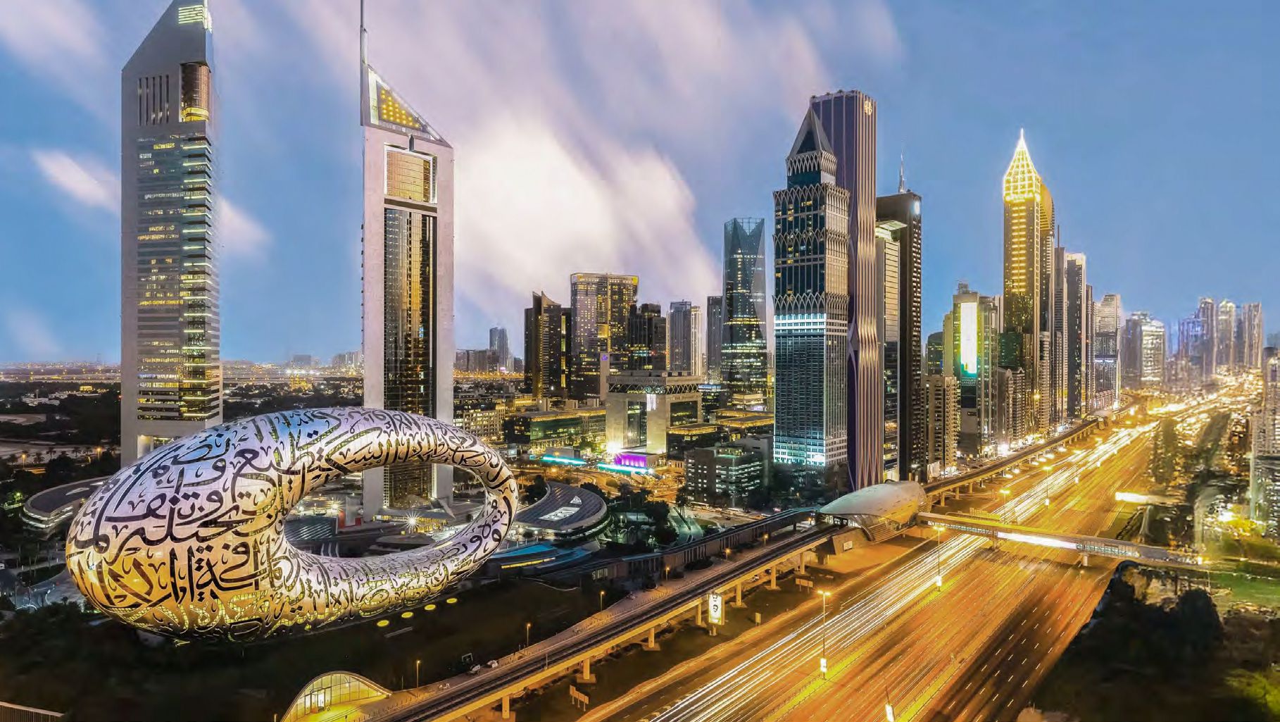 Night view of Museum of the Future and Ash Tower. Premium real estate services for Dubai’s most famous views.