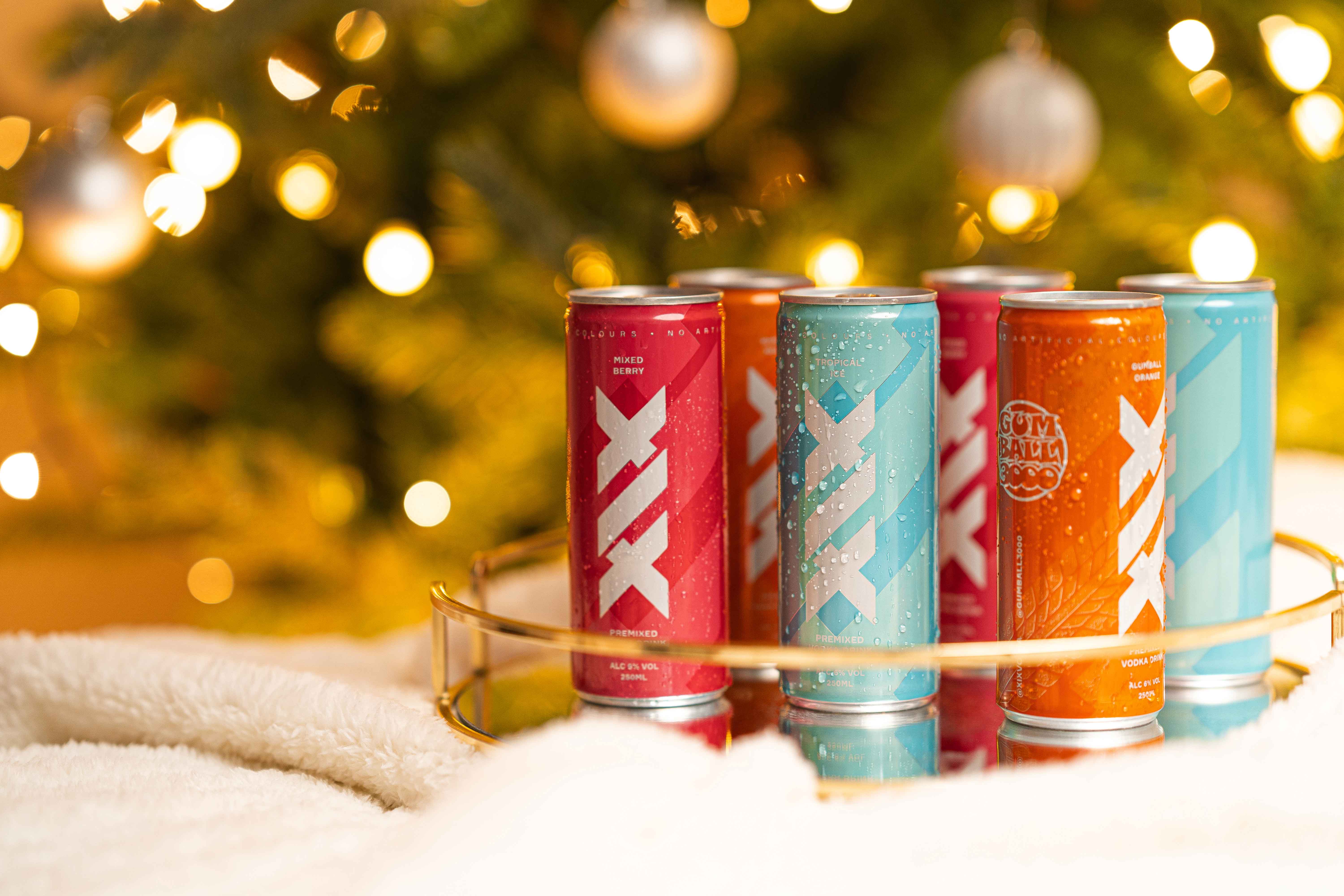 man wearing a silver jacket and pants sitting on a car