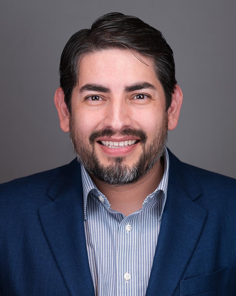 image of man wearing glasses folding his arms