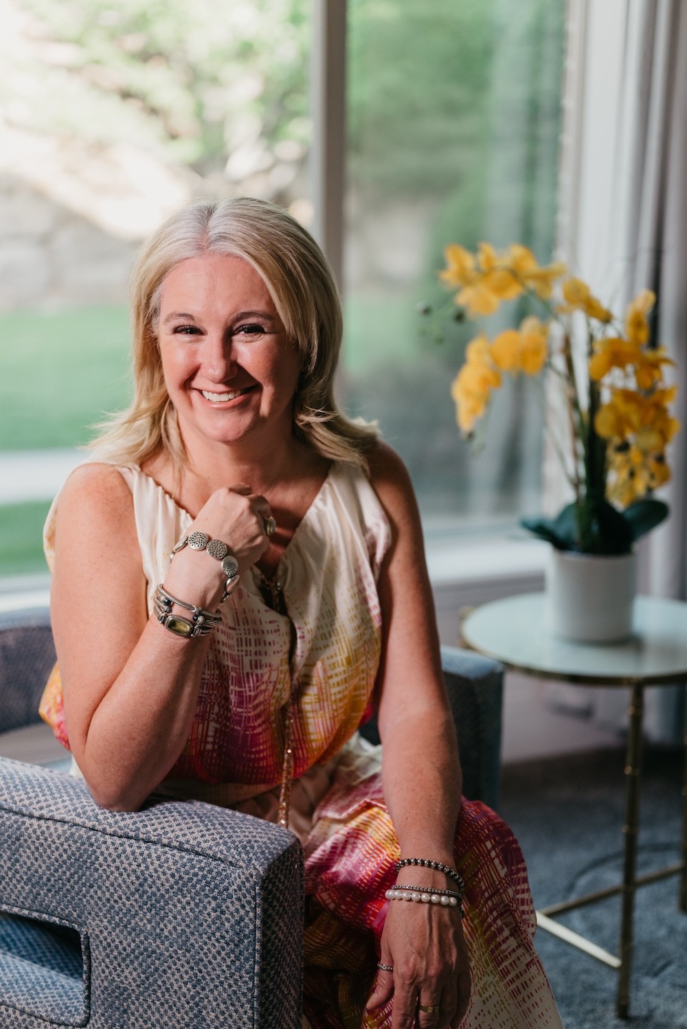 Black and white portrait of a smiling person with curly hair