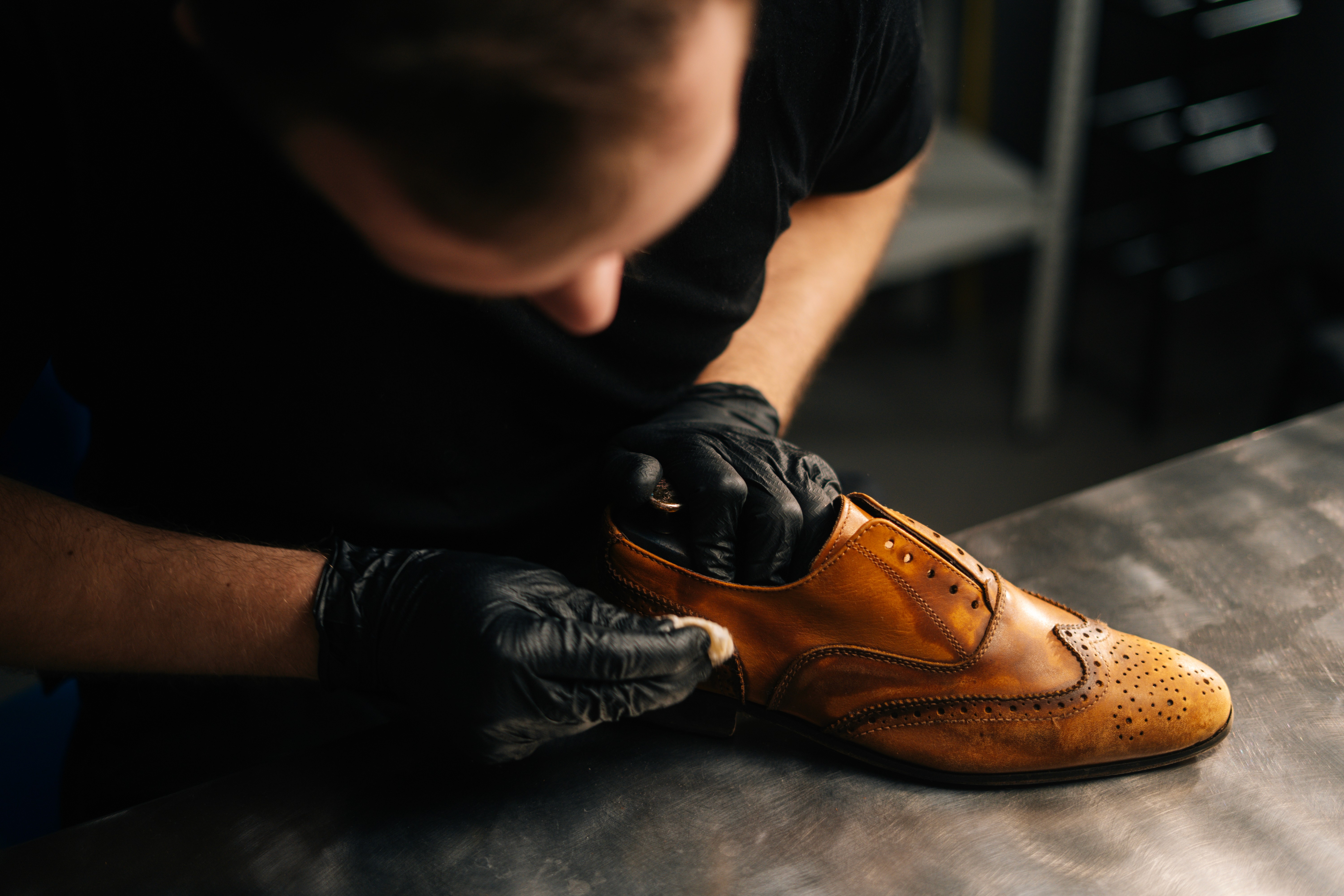 Shoe maker polishing shoes