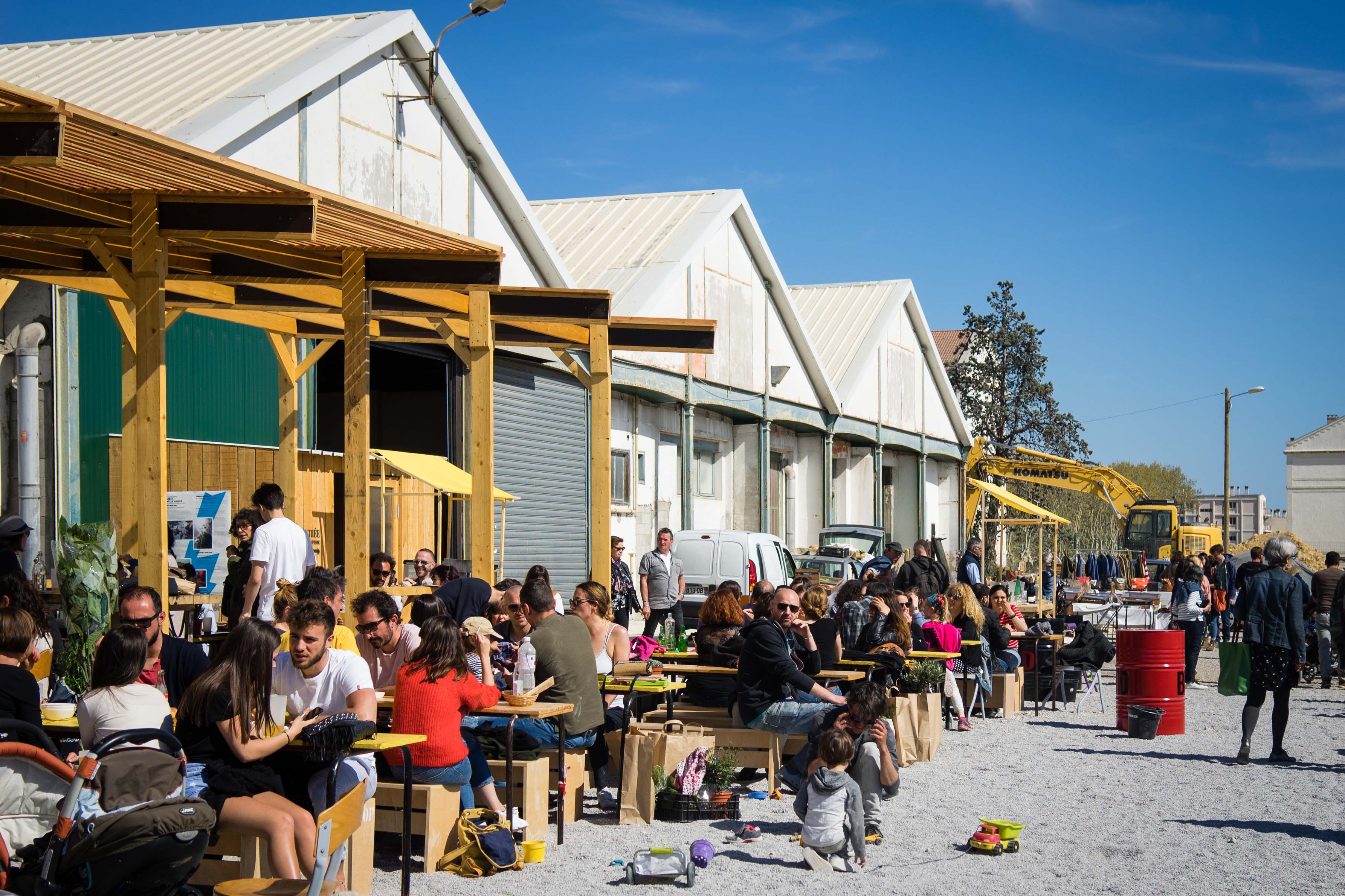 man wearing headphones while sitting on chair in front of MacBook