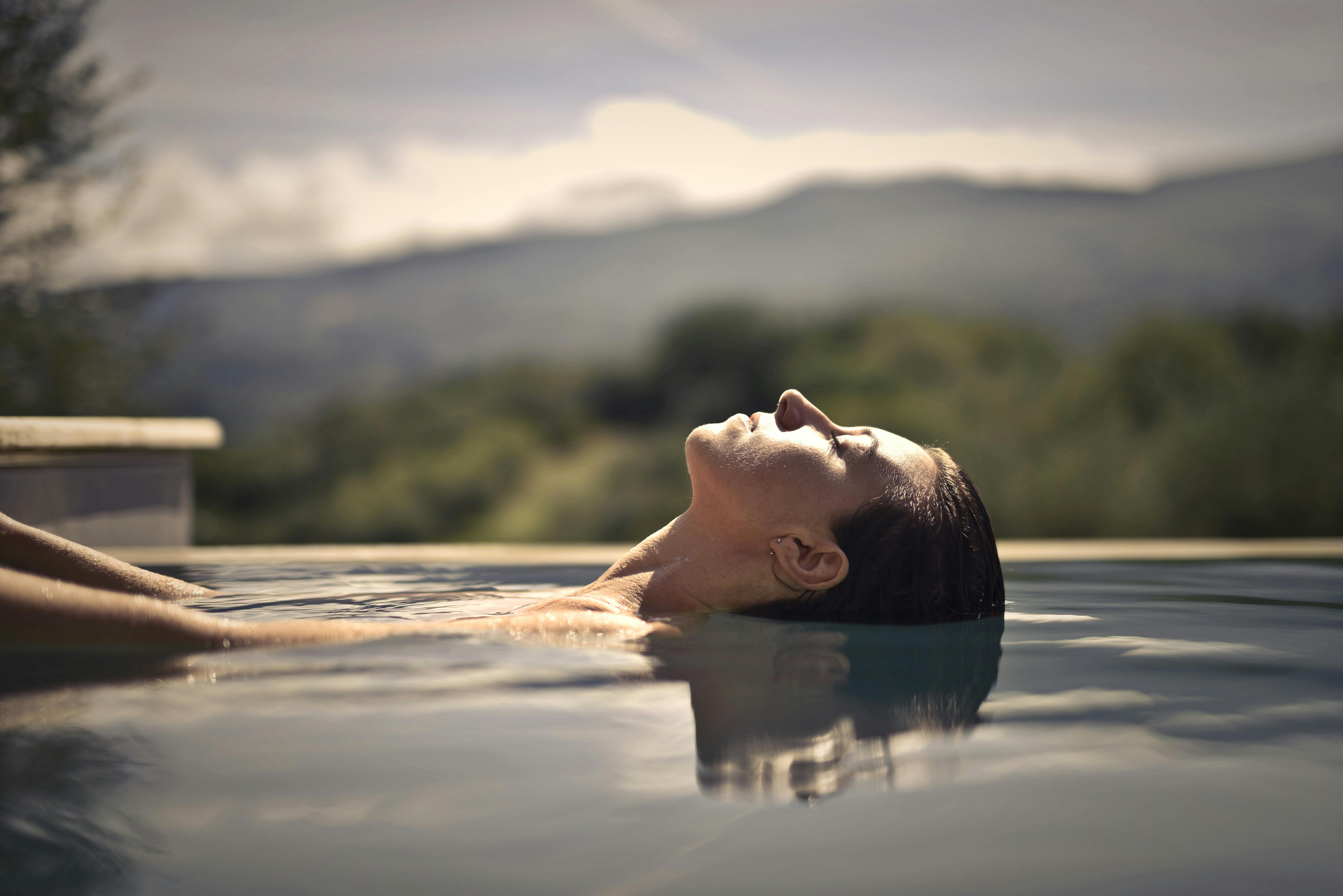 A woman relaxes in a hotel with a mountain view