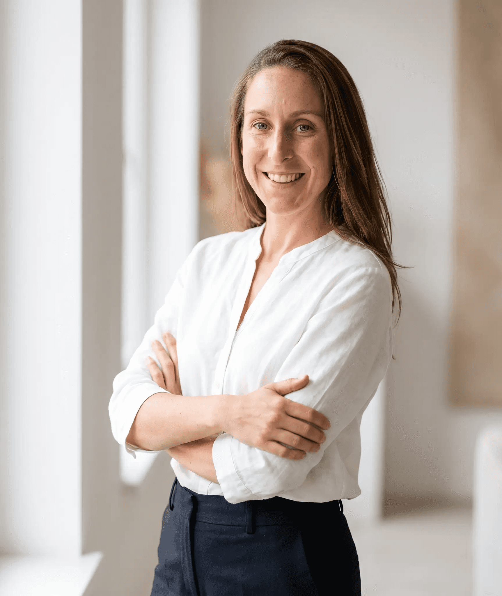 woman in white long sleeve shirt smiling