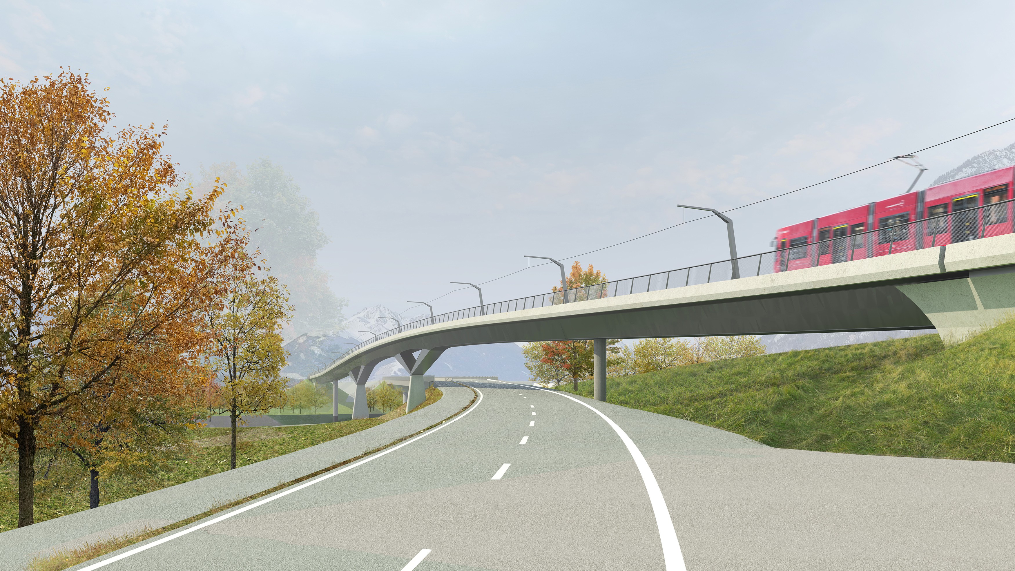 Light rail crossing a curved bridge above a road lined with grassy verge and autumn trees.