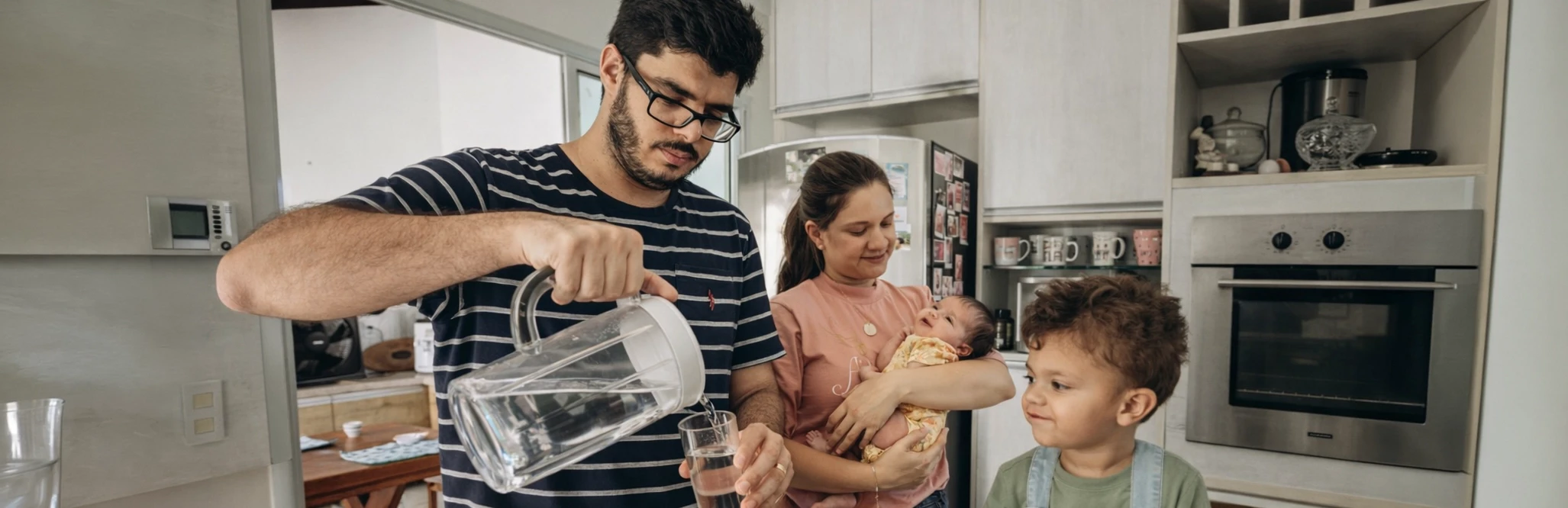 Texas Dad with his family, pouring drinking water into a glass.