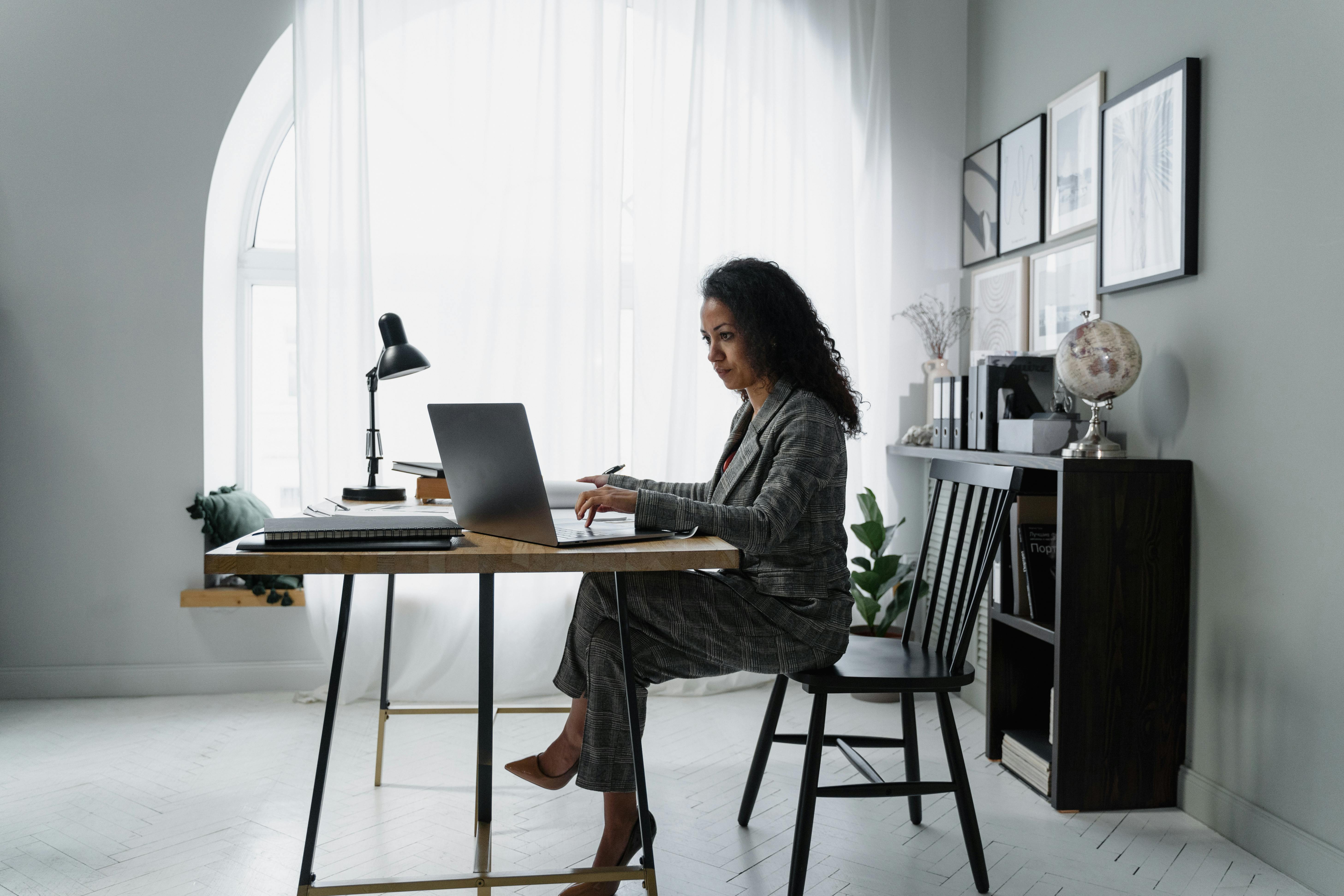 Woman sitting on chair studying how to qualify for a mortgage