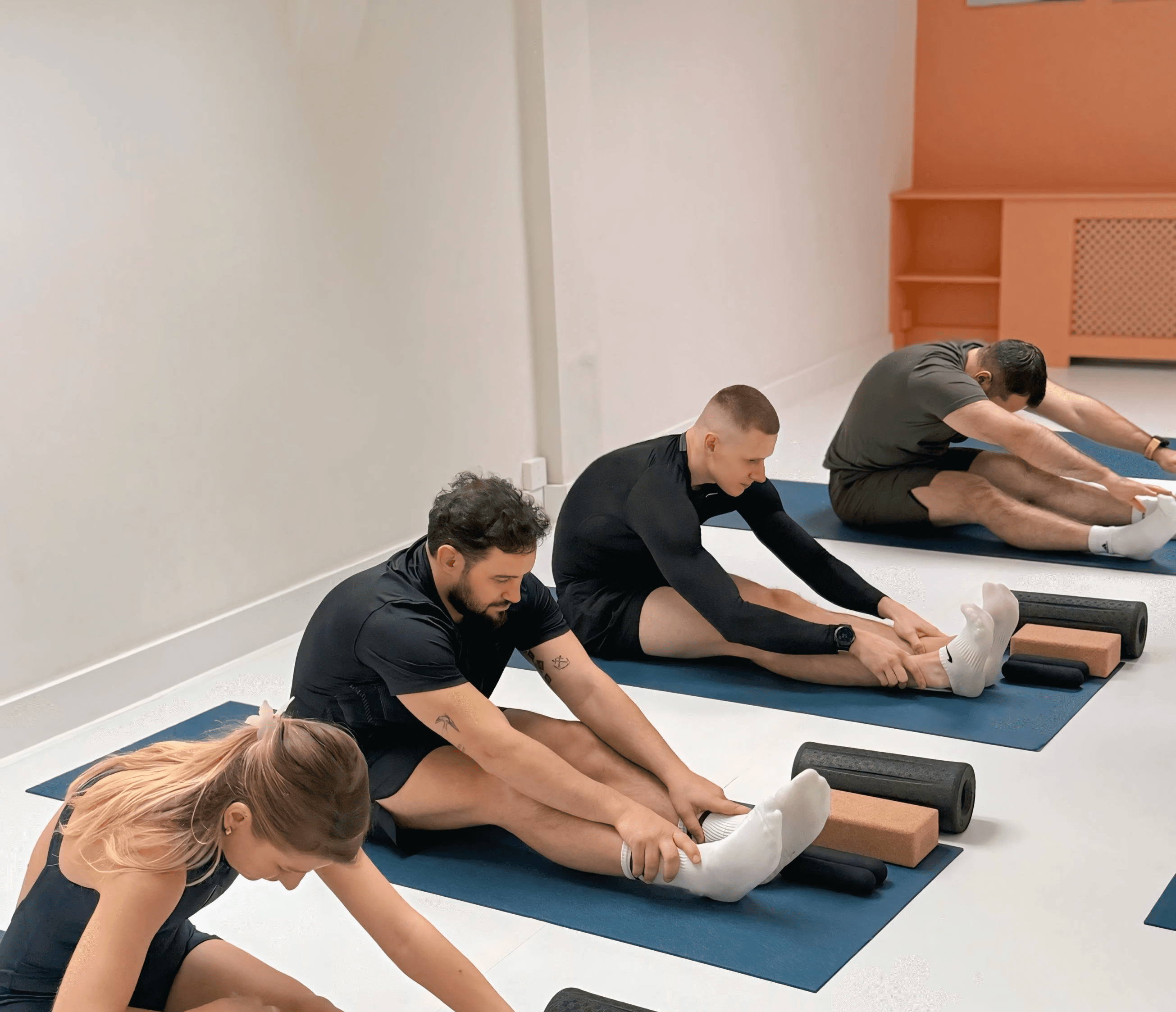 Aerial view of a winding road cutting through rocky terrain with patches of grass.