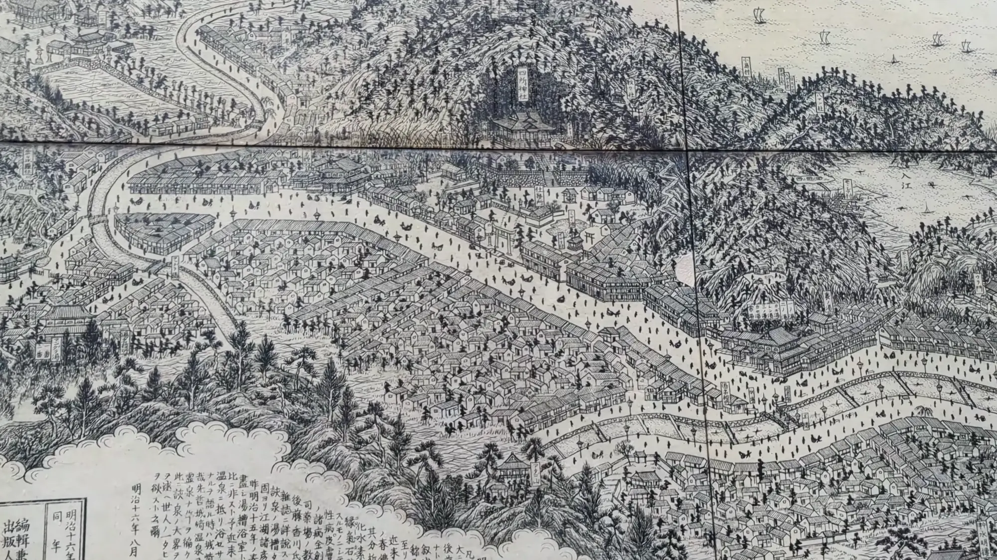 Historical woodblock panorama of Kinosaki showing the river, the bath street and the surrounding hills.