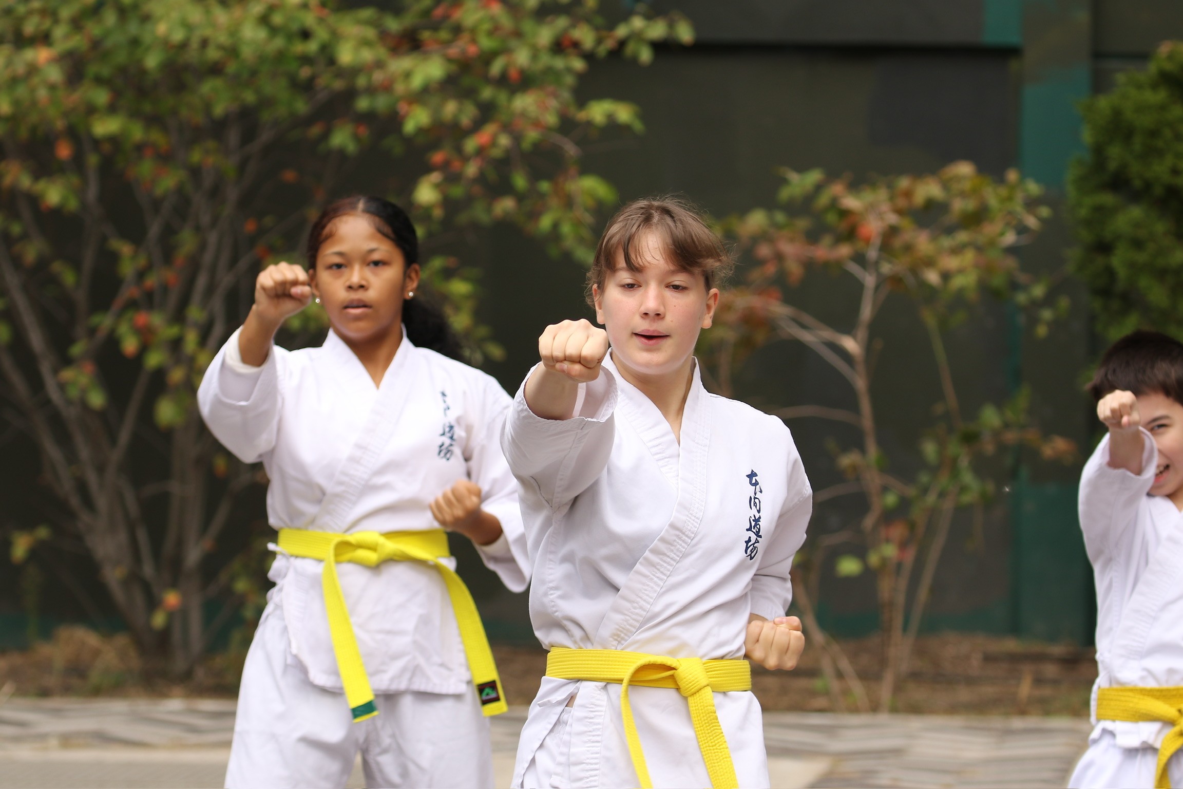 Freshly baked Margherita pizza with melted cheese, tomato sauce, and basil leaves, held by a person’s hand.