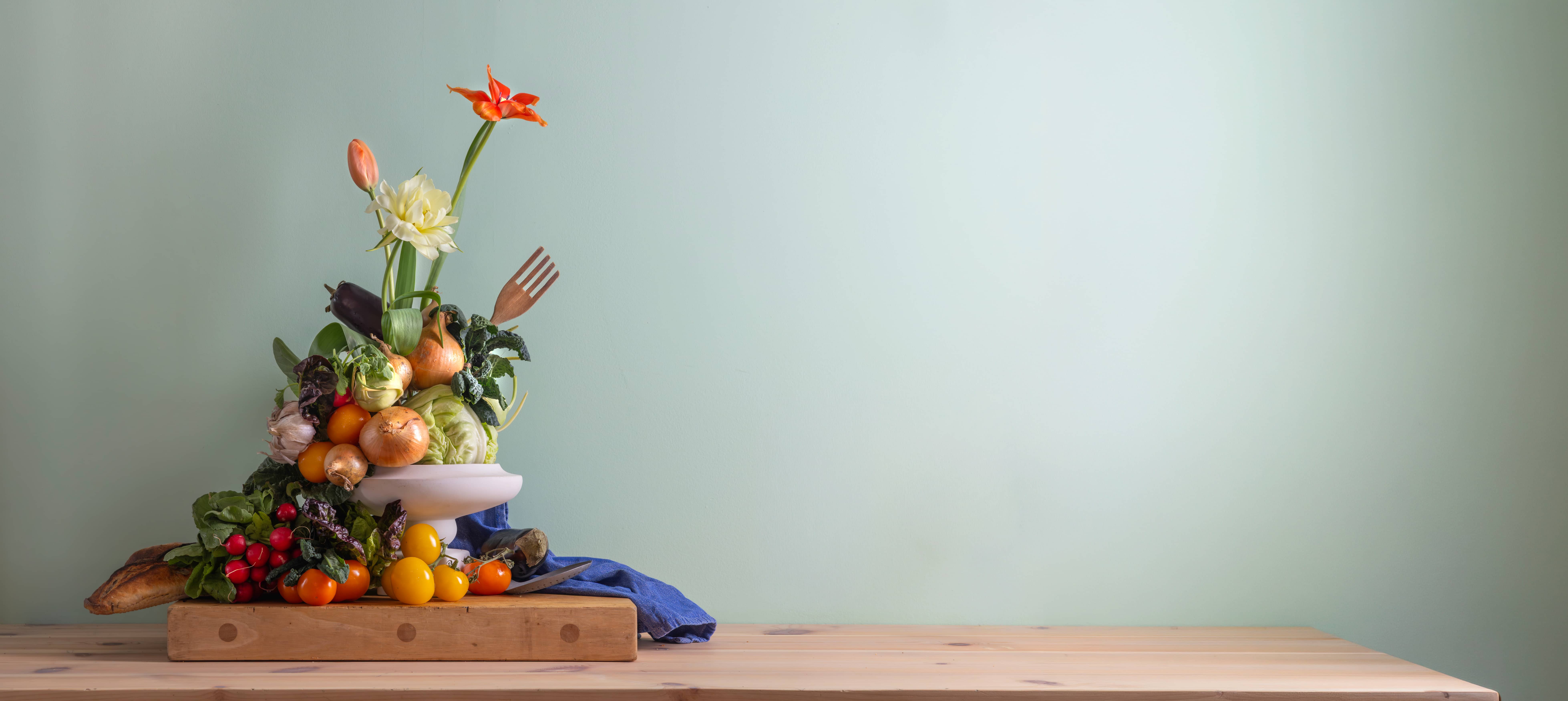  flower arrangement with vegetables on table