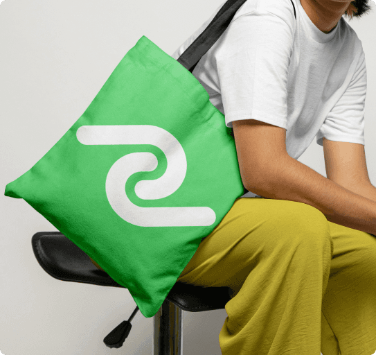 Close-up of a yellow tennis ball sitting on a green court, positioned near the white center line.