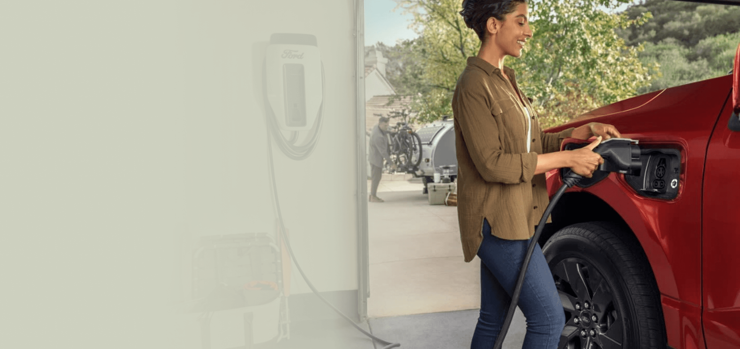 Woman charging her electric Ford truck