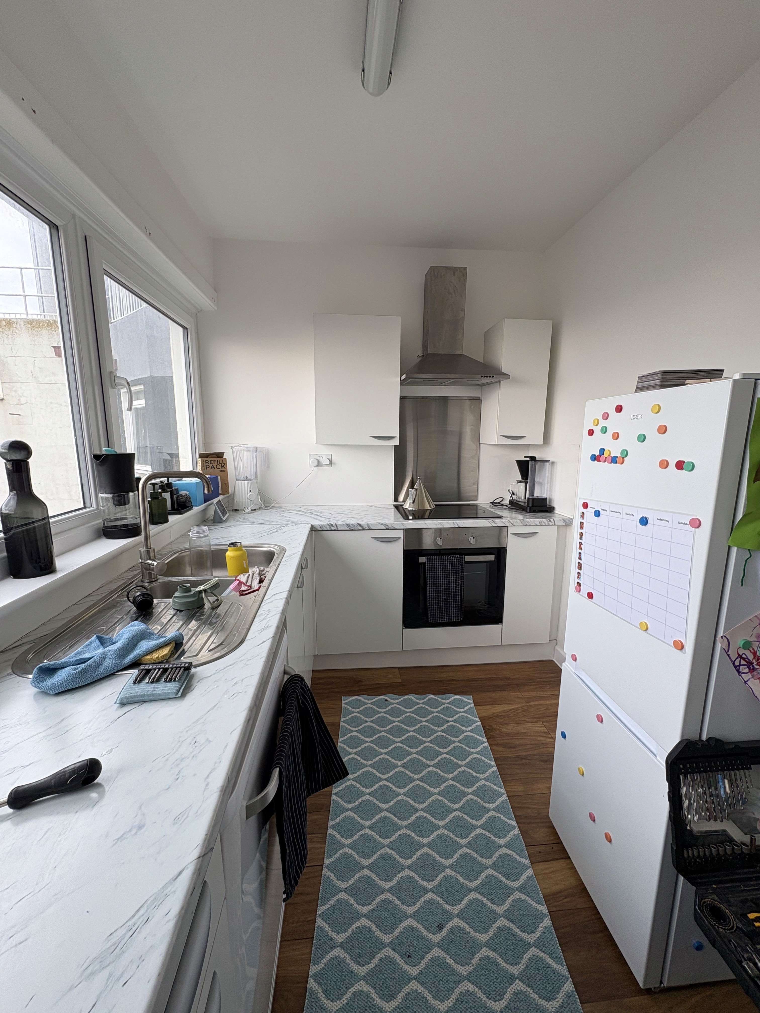 Before: traditional kitchen with dated cabinetry and tiled flooring