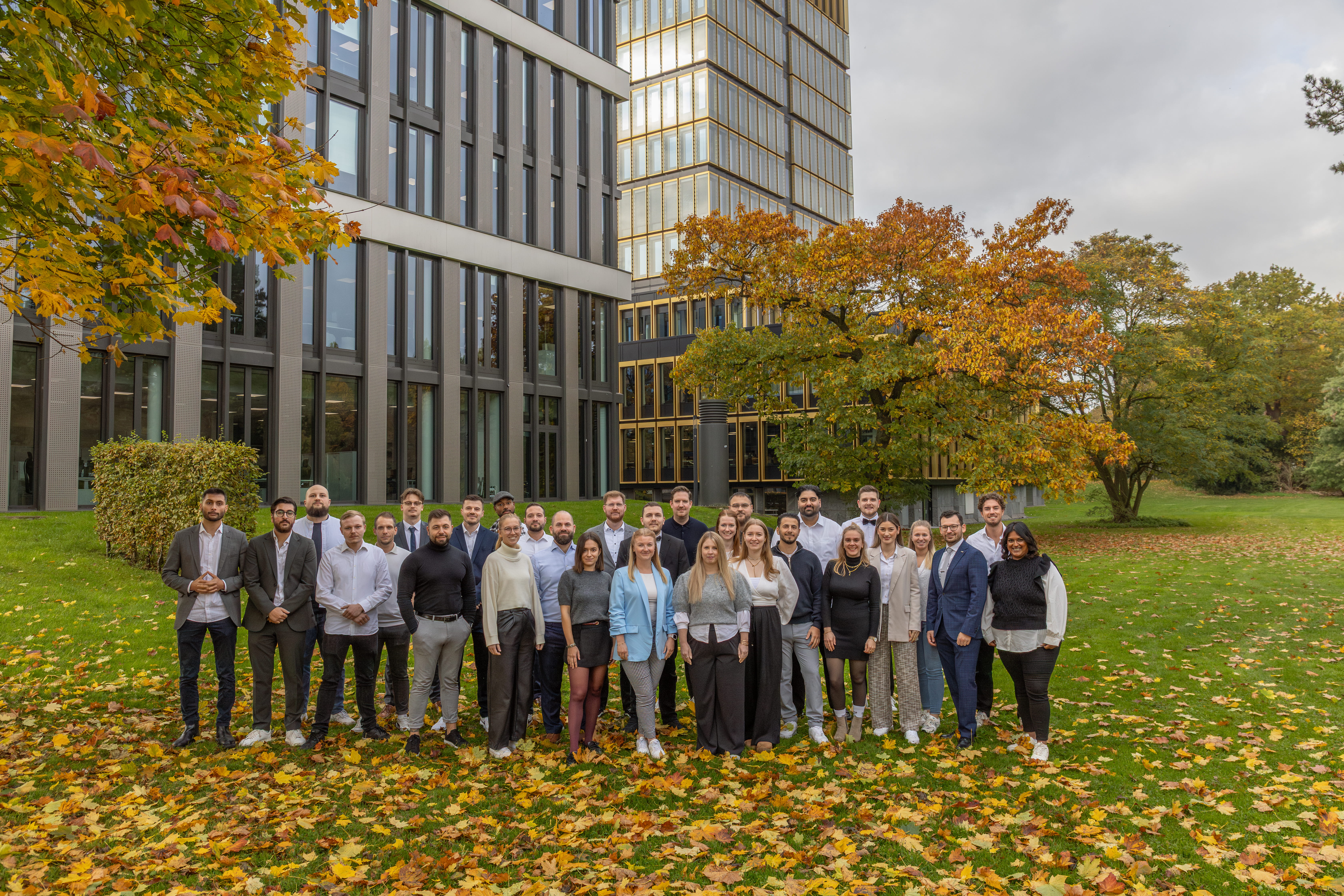 Female scientist wearing a white coat and gloves examines a sample slide in a modern laboratory setting.