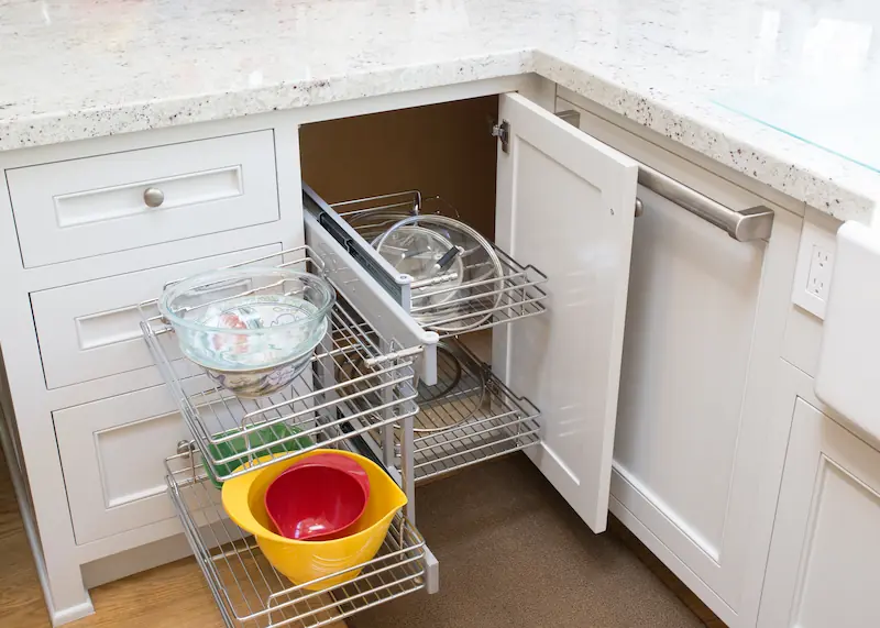 Close-up of retractable cabnet rack in the lower kitchen cabinetry with quartz countertop from the Big Canyon Remodel project. Photo by Chris Darnall.
